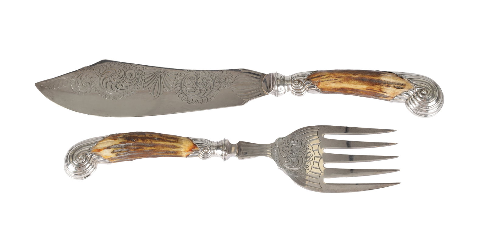A SET OF VICTORIAN ENGLISH SILVER AND STAG HORN FISH SERVERS: A SET OF VICTORIAN ENGLISH SILVER AND STAG HORN FISH SERVERS comprising a knife and fork with engraved scroll and shell ornament to the blades and tines, stag horn handles with silver ferrules and