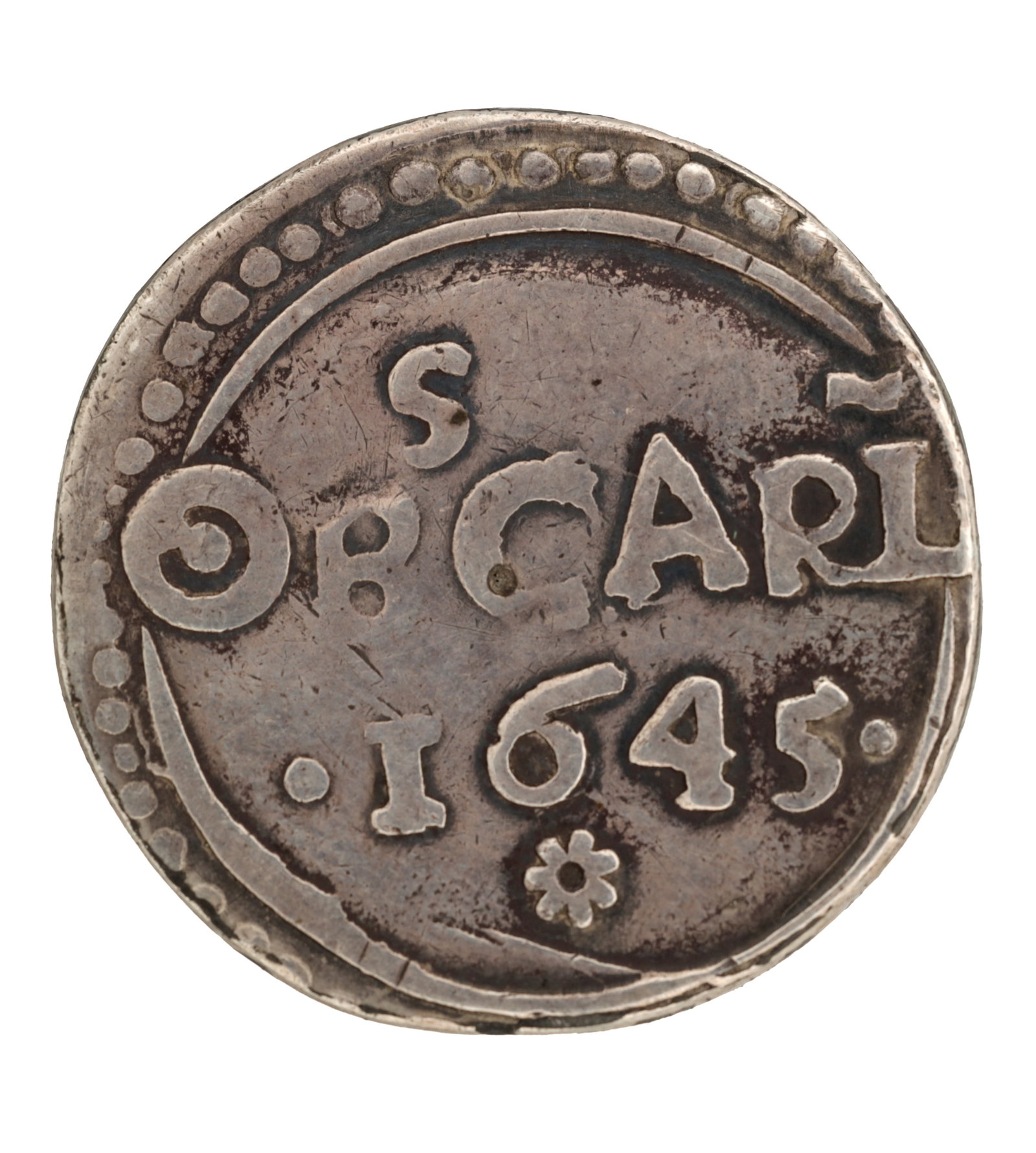 A RARE 1645 ENGLISH SILVER CARLISLE SIEGE SHILLING OF CHARLES I: A RARE 1645 ENGLISH SILVER CARLISLE SIEGE SHILLING OF CHARLES I of crude circular flan with a beaded border inscribed CARL and dated 1645 with rosette below, app. 12.5g. (approx. 12.5 g)