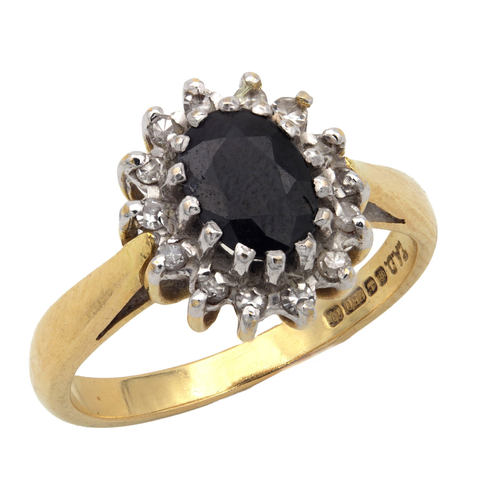 AN 18CT YELLOW GOLD SAPPHIRE AND DIAMOND RING: AN 18CT YELLOW GOLD SAPPHIRE AND DIAMOND RING central 0.75 carat oval cut sapphire within a surround of fourteen diamonds, the shank fully hallmarked internally with maker's mark TAD, the common contr