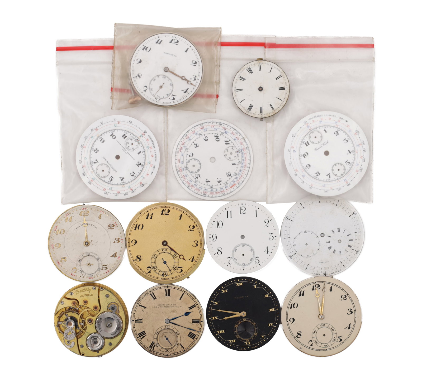 A COLLECTION OF SWISS POCKET WATCH MOVEMENTS AND DIALS: A COLLECTION OF SWISS POCKET WATCH MOVEMENTS AND DIALS comprising assorted enamel and metal pocket watch dials with Arabic and Roman numerals, several with multi-scale chronograph and telemeter calibr