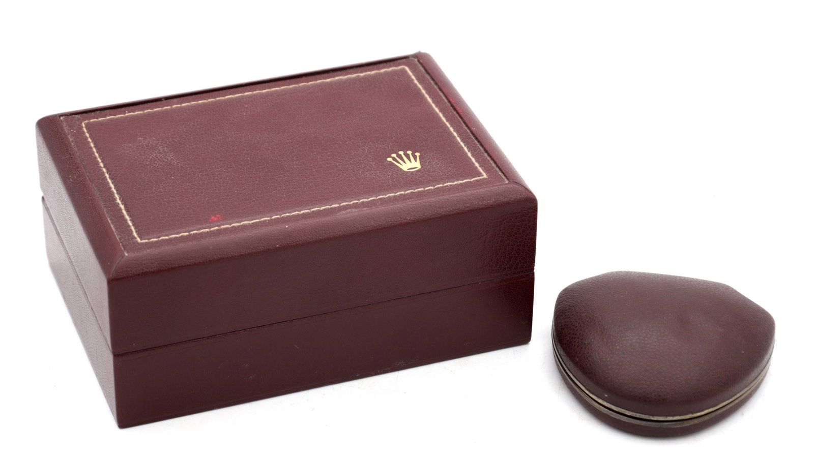 TWO VINTAGE ROLEX WRIST WATCH BOXES: TWO VINTAGE ROLEX WRIST WATCH BOXES comprising a rectangular hinged example in burgundy leatherette with gilt tooled border and crown device to the lid together with a burgundy clam-shaped hinged trav