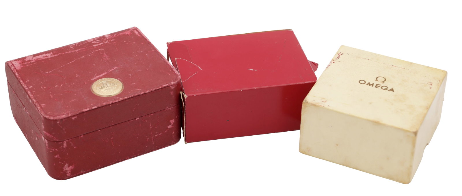 THREE VINTAGE OMEGA WRIST WATCH BOXES: THREE VINTAGE OMEGA WRIST WATCH BOXES comprising a red hinged presentation case with gilt roundel, a red card outer box and a cream card box printed Omega, each of rectangular form.