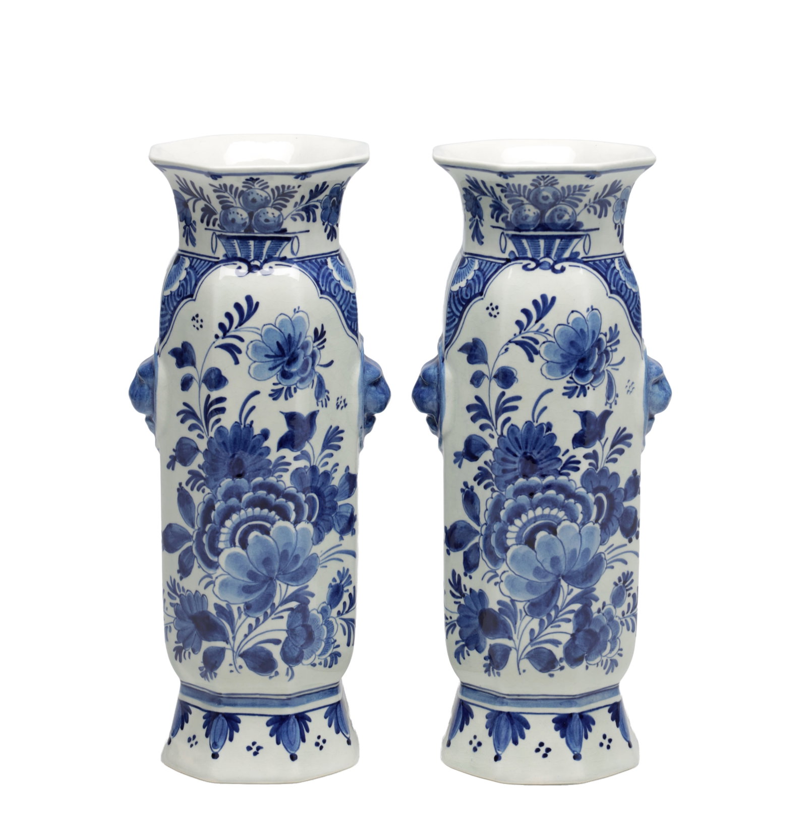 A PAIR OF EARLY 20TH CENTURY DELFT BLUE AND WHITE PORCELAIN VASES: A PAIR OF EARLY 20TH CENTURY DELFT BLUE AND WHITE PORCELAIN VASES of octagonal section with flared rims and spreading feet, each with applied mask handles to the shoulders and painted with floral pane