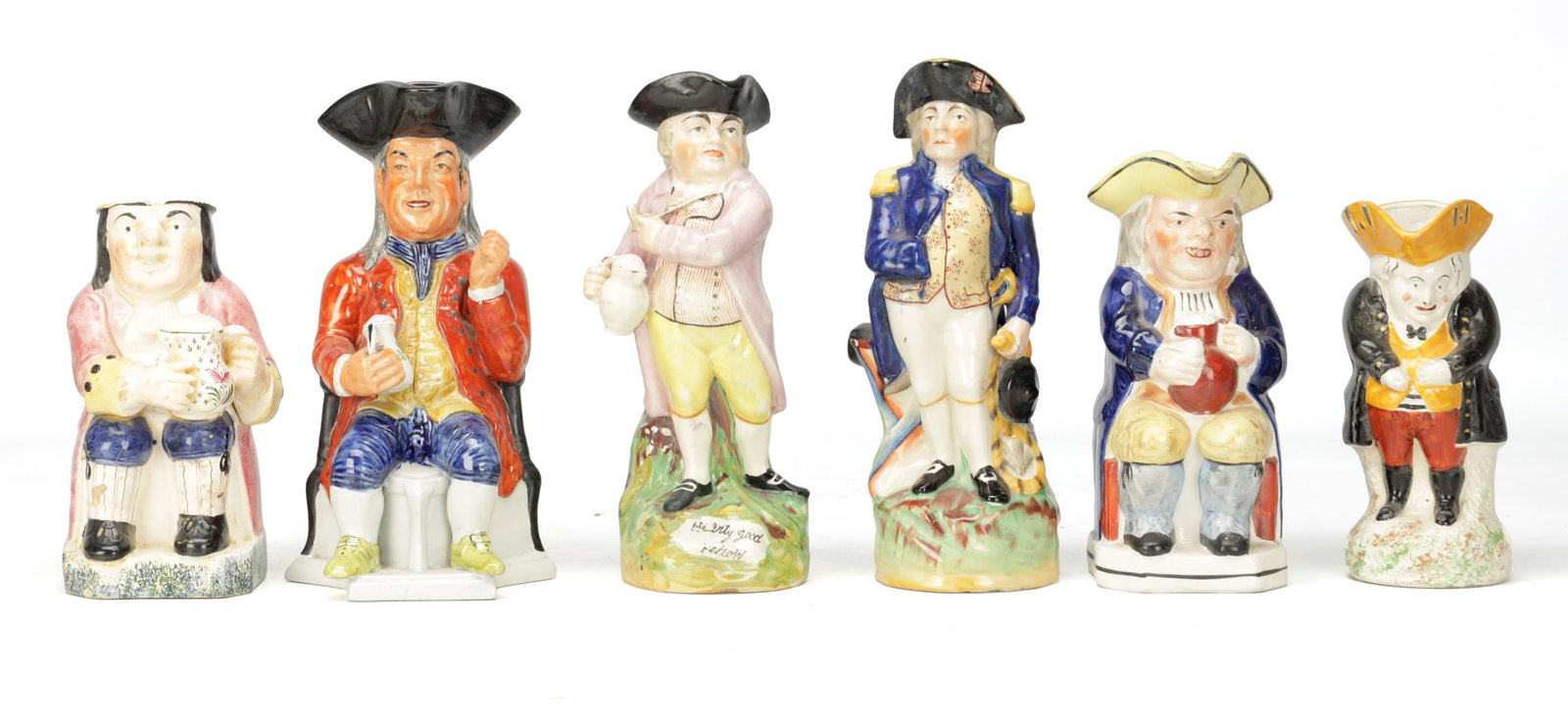 A COLLECTION OF 18TH AND 19TH CENTURY ENGLISH STAFFORDSHIRE POTTERY TOBY JUGS: A COLLECTION OF 18TH AND 19TH CENTURY ENGLISH STAFFORDSHIRE POTTERY TOBY JUGS comprising six polychrome glazed examples of seated and standing figures with tricorn hats and ale jugs, one titled The Jo