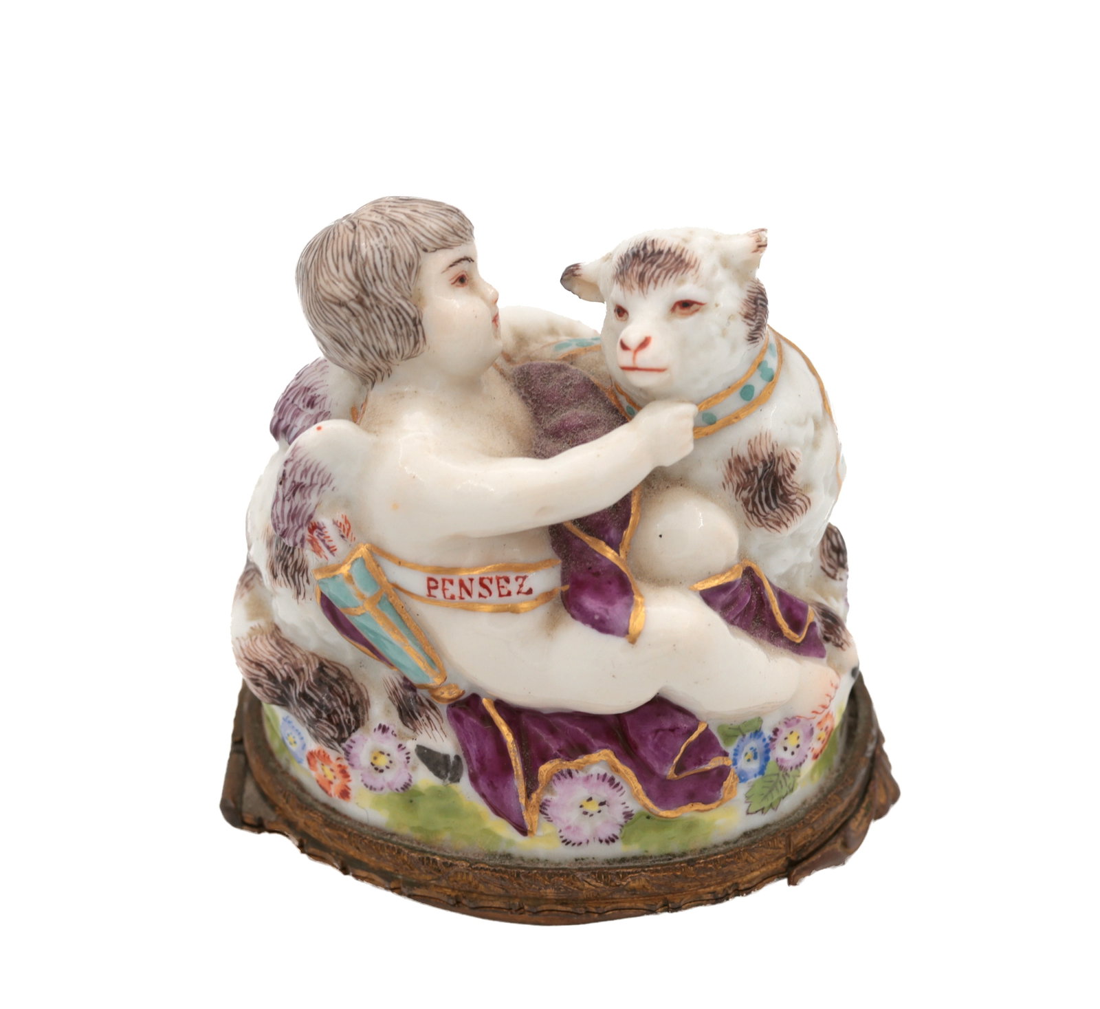 A 19TH CENTURY FRENCH PORCELAIN FIGURAL BONBONNIERE MODELLED AS A PUTTO AND LAMB: A 19TH CENTURY FRENCH PORCELAIN FIGURAL BONBONNIERE MODELLED AS A PUTTO AND LAMB finely painted in polychrome and gilt, the ribbon inscribed Pensez, on a gilt-metal mount. (5cm high)