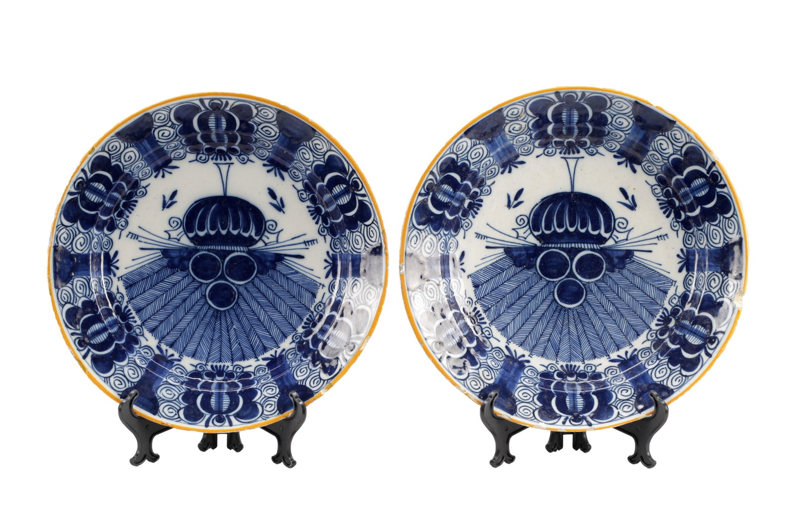 A PAIR OF EARLY 18TH CENTURY DUTCH DELFTWARE BLUE AND WHITE CHARGERS: A PAIR OF EARLY 18TH CENTURY DUTCH DELFTWARE BLUE AND WHITE CHARGERS of circular form with everted rims, tin-glazed and painted in cobalt with a stylised fan device to the well and floral cartouches t