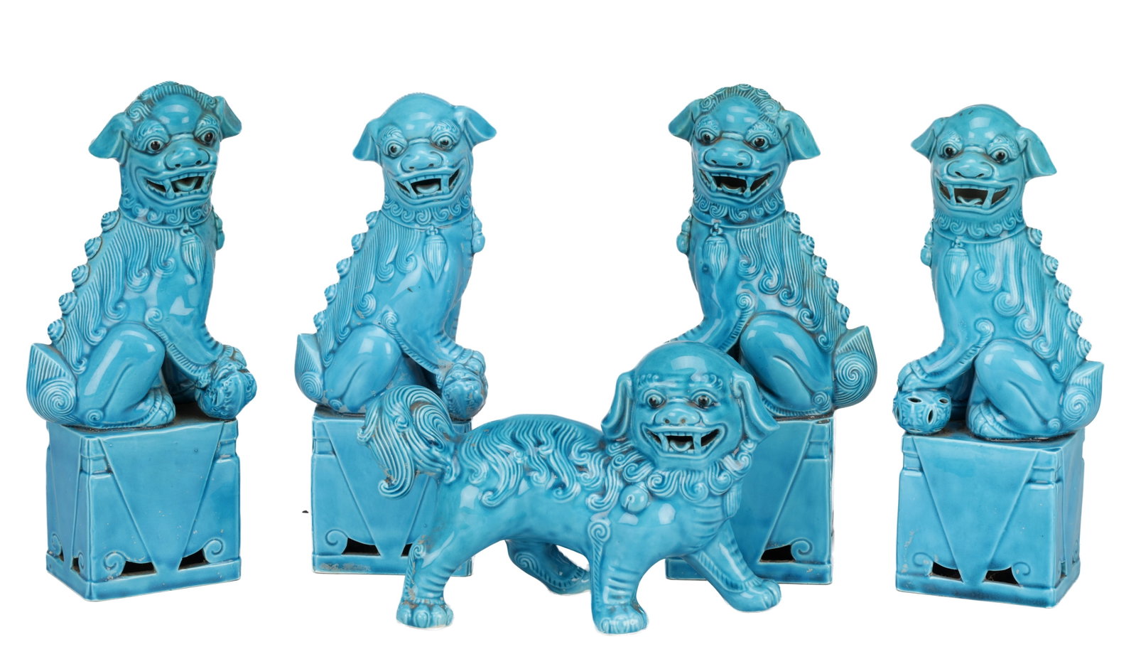 A COLLECTION OF FIVE 20TH CENTURY CHINESE TURQUOISE GLAZED CERAMIC BUDDHIST LIONS: A COLLECTION OF FIVE 20TH CENTURY CHINESE TURQUOISE GLAZED CERAMIC BUDDHIST LIONS comprising four seated examples on square pierced bases and one standing example, each with curled mane and open jaws 