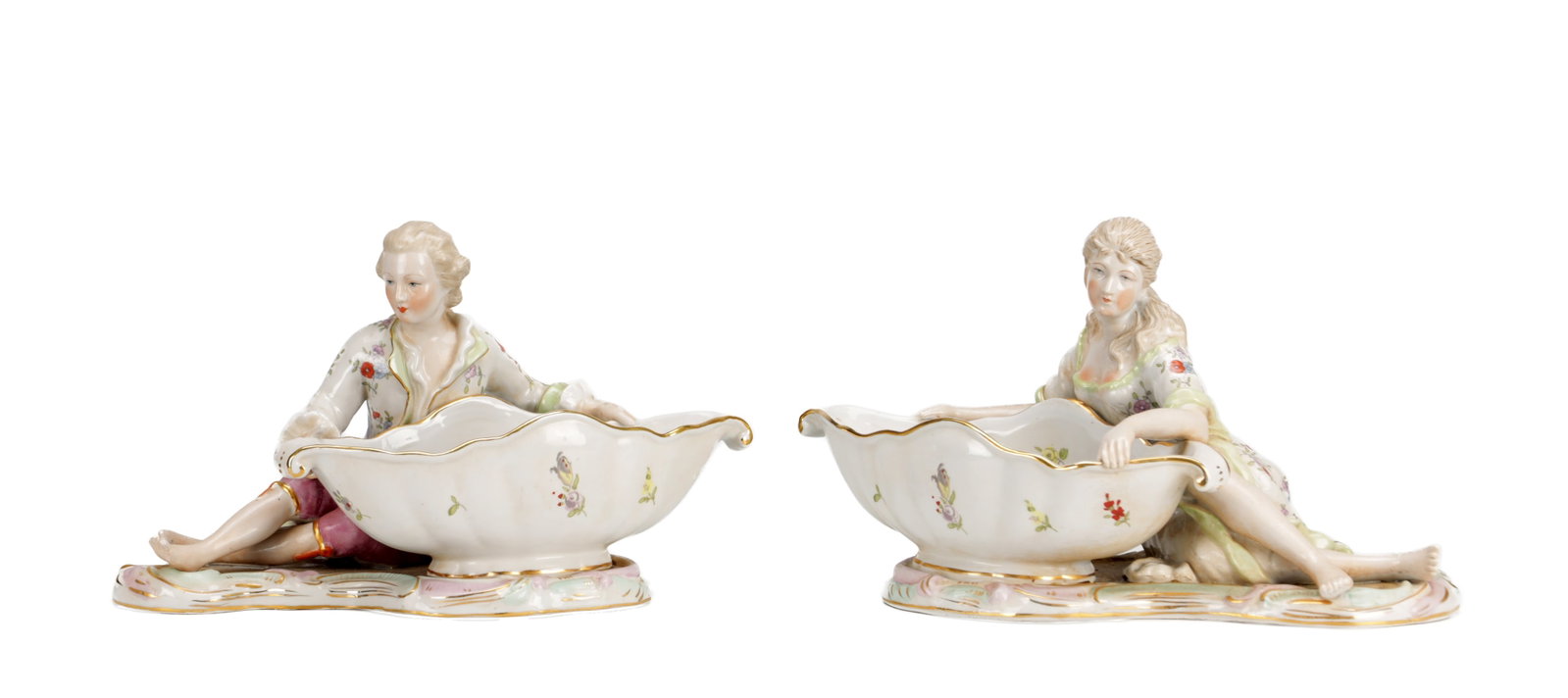 A PAIR OF LATE 19TH CENTURY / EARLY 20TH CENTURY CONTINENTAL PORCELAIN MEISSEN STYLE FIGURAL: A PAIR OF LATE 19TH CENTURY / EARLY 20TH CENTURY CONTINENTAL PORCELAIN MEISSEN STYLE FIGURAL SWEETMEAT DISHES modelled as a seated gallant and companion, each supporting shell-moulded bowls with gilt 
