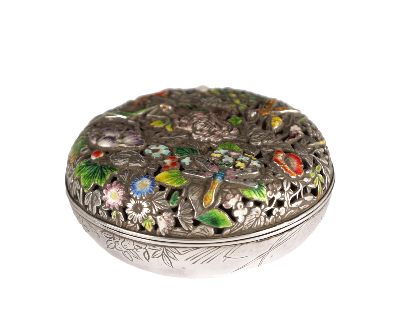 A JAPANESE MEIJI PERIOD SILVER AND ENAMEL BOX AND COVER: A JAPANESE MEIJI PERIOD SILVER AND ENAMEL BOX AND COVER of circular form, the domed pierced cover enamelled with polychrome flowers foliage and insects, the base engraved with floral sprays, signed be