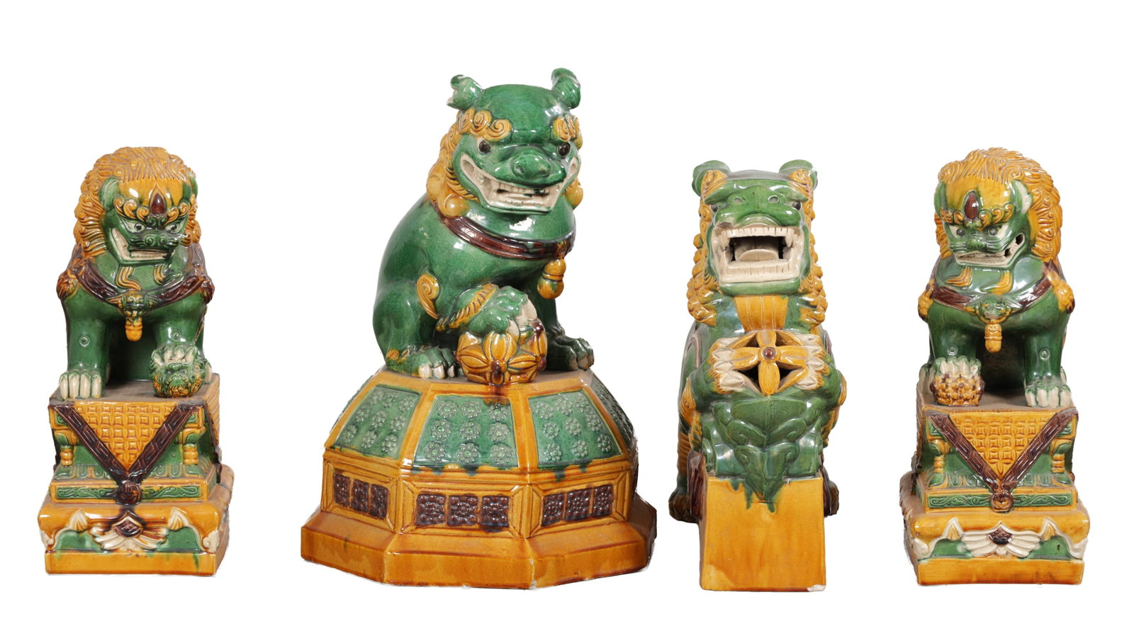 A COLLECTION OF FOUR EARLY 20TH CENTURY CHINESE POLYCHROME GLAZED EARTHENWARE GUARDIAN LIONS (1 of 4)