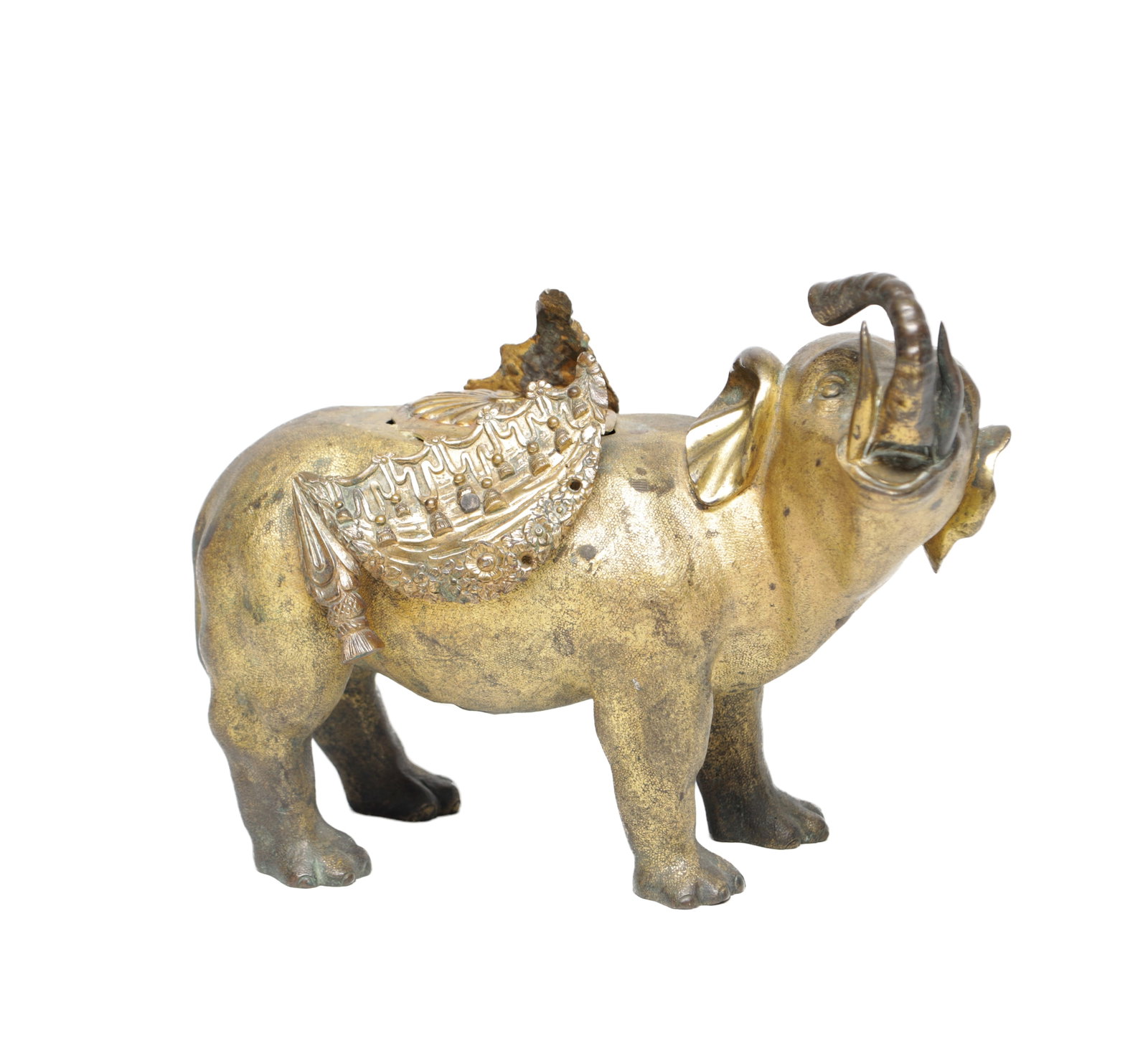 A 19TH CENTURY EASTERN GILT BRONZE MODEL OF A CAPARISONED ELEPHANT: A 19TH CENTURY EASTERN GILT BRONZE MODEL OF A CAPARISONED ELEPHANT cast and chased in the round with raised trunk and tusks, the body draped with an ornate saddle cloth and howdah with pendant tassels
