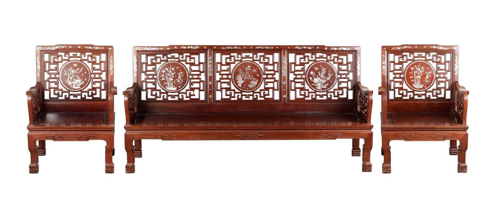 A 20TH CENTURY CHINESE HARDWOOD AND MOTHER OF PEARL INLAID THREE PIECE SUITE: A 20TH CENTURY CHINESE HARDWOOD AND MOTHER OF PEARL INLAID THREE PIECE SUITE comprising a settee and two armchairs each with pierced rectangular backs centred by circular medallions inlaid with birds
