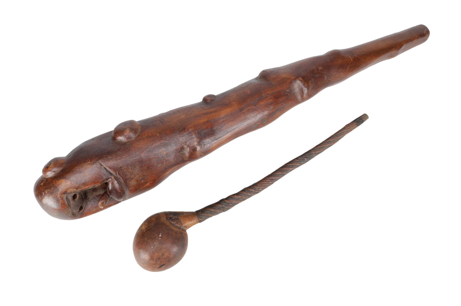 TWO AFRICAN CARVED WOOD CLUBS: TWO AFRICAN CARVED WOOD CLUBS comprising a heavy rootwood example carved with a zoomorphic terminal and raised bosses together with a knobkerrie with bulbous head and wire-bound shaft. (95cm long and
