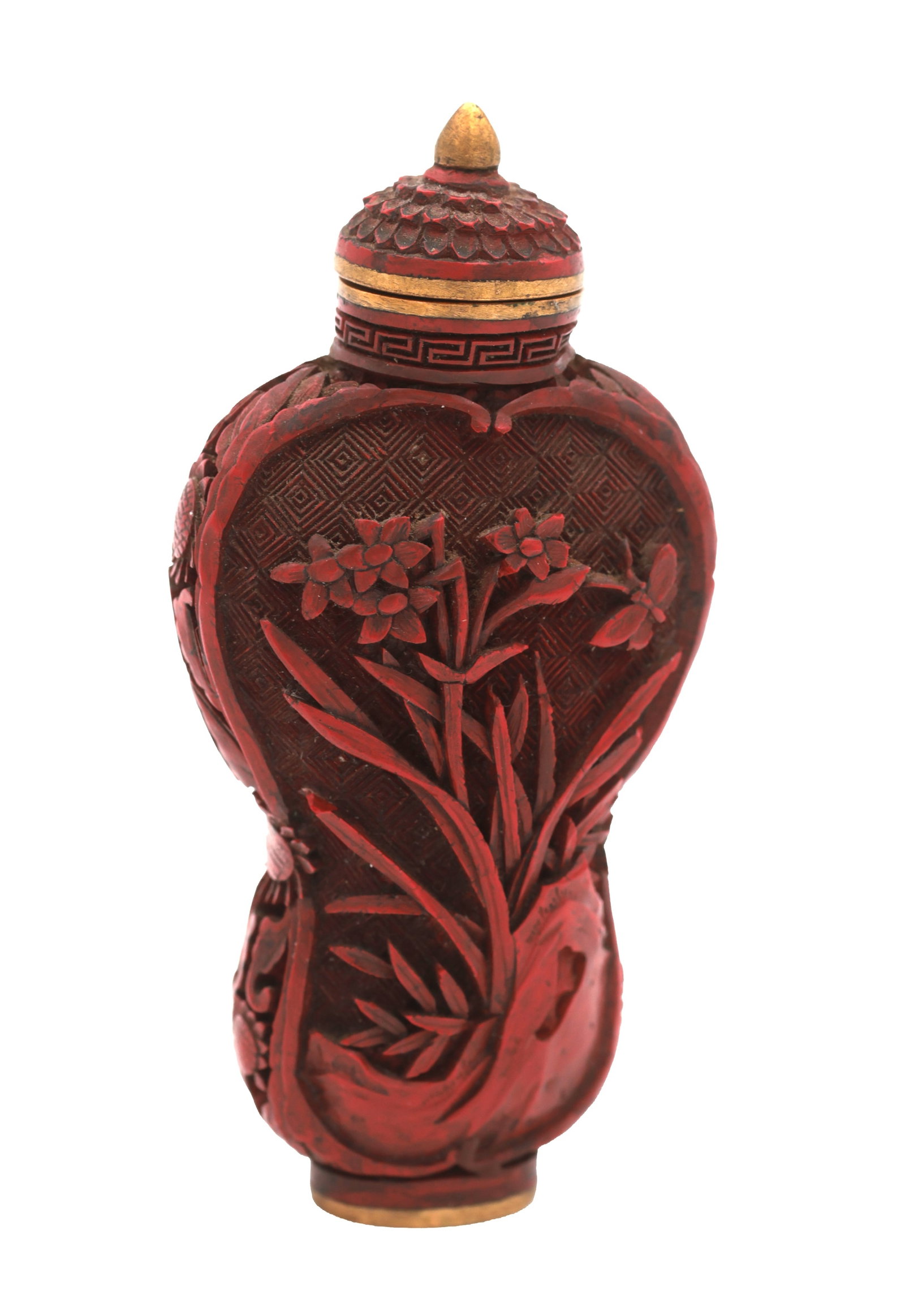 AN EARLY 19TH CENTURY CHINESE CARVED CINNABAR SNUFF BOTTLE: AN EARLY 19TH CENTURY CHINESE CARVED CINNABAR SNUFF BOTTLE of flattened baluster form with relief-carved floral panels on a diaper ground, the domed cover with conical finial and key-fret band, with