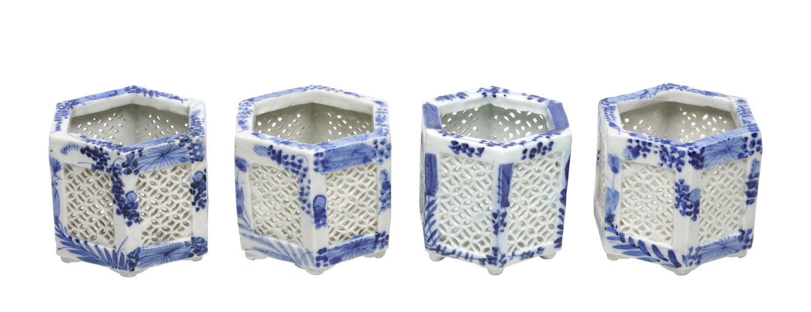 A SET OF FOUR JAPANESE BLUE AND WHITE PORCELAIN HEXAGONAL CRICKET CAGES: A SET OF FOUR JAPANESE BLUE AND WHITE PORCELAIN HEXAGONAL CRICKET CAGES each of openwork hexagonal form with reticulated lattice panels and underglaze blue floral decoration raised on small knop