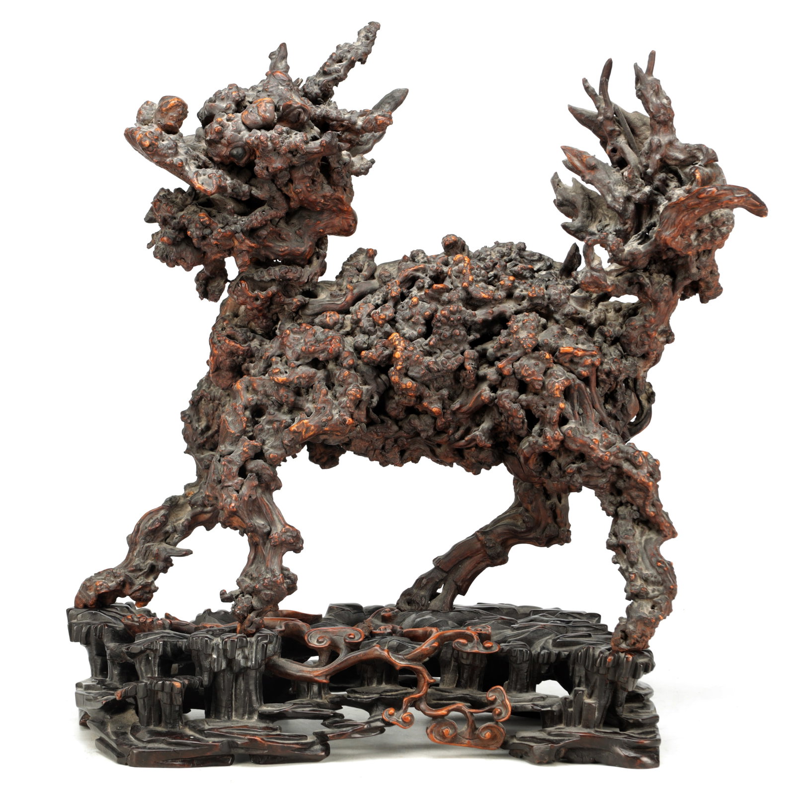 A 19TH CENTURY CHINESE ROOTWOOD SCULPTURE: A 19TH CENTURY CHINESE ROOTWOOD SCULPTURE modelled as a mythical beast with branching antlers and raised tail on a carved and pierced hardwood stand. (60cm high)