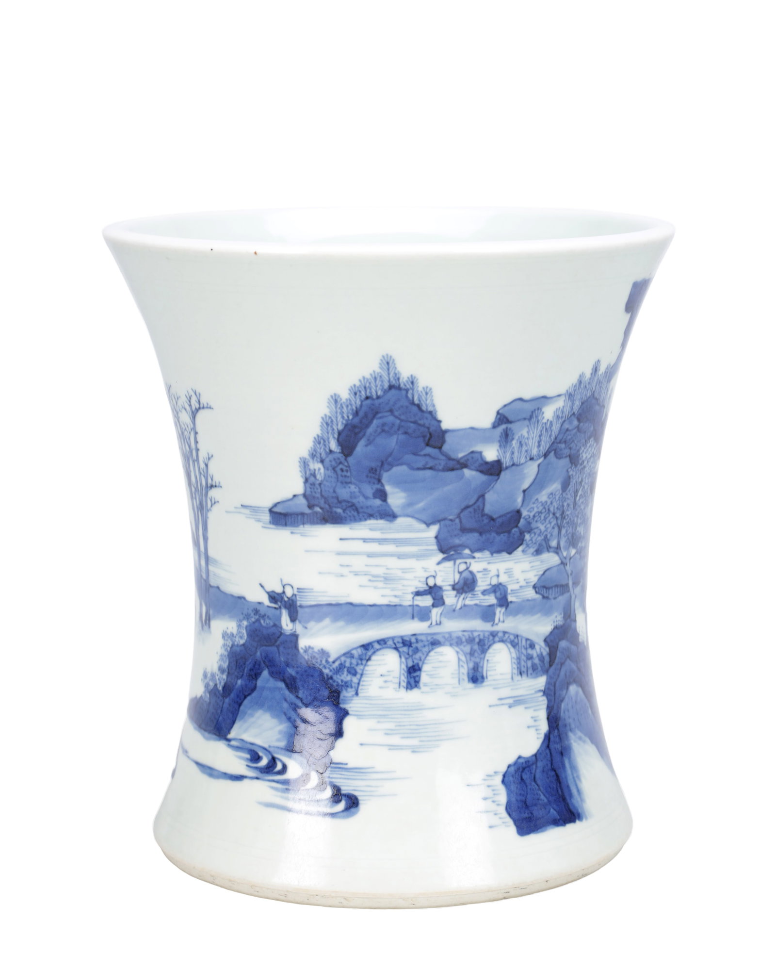 A CHINESE BLUE AND WHITE PORCELAIN BRUSH POT: A CHINESE BLUE AND WHITE PORCELAIN BRUSH POT of waisted flared form with everted rim, painted with a continuous river landscape with figures crossing an arched bridge among rocky outcrops and trees in