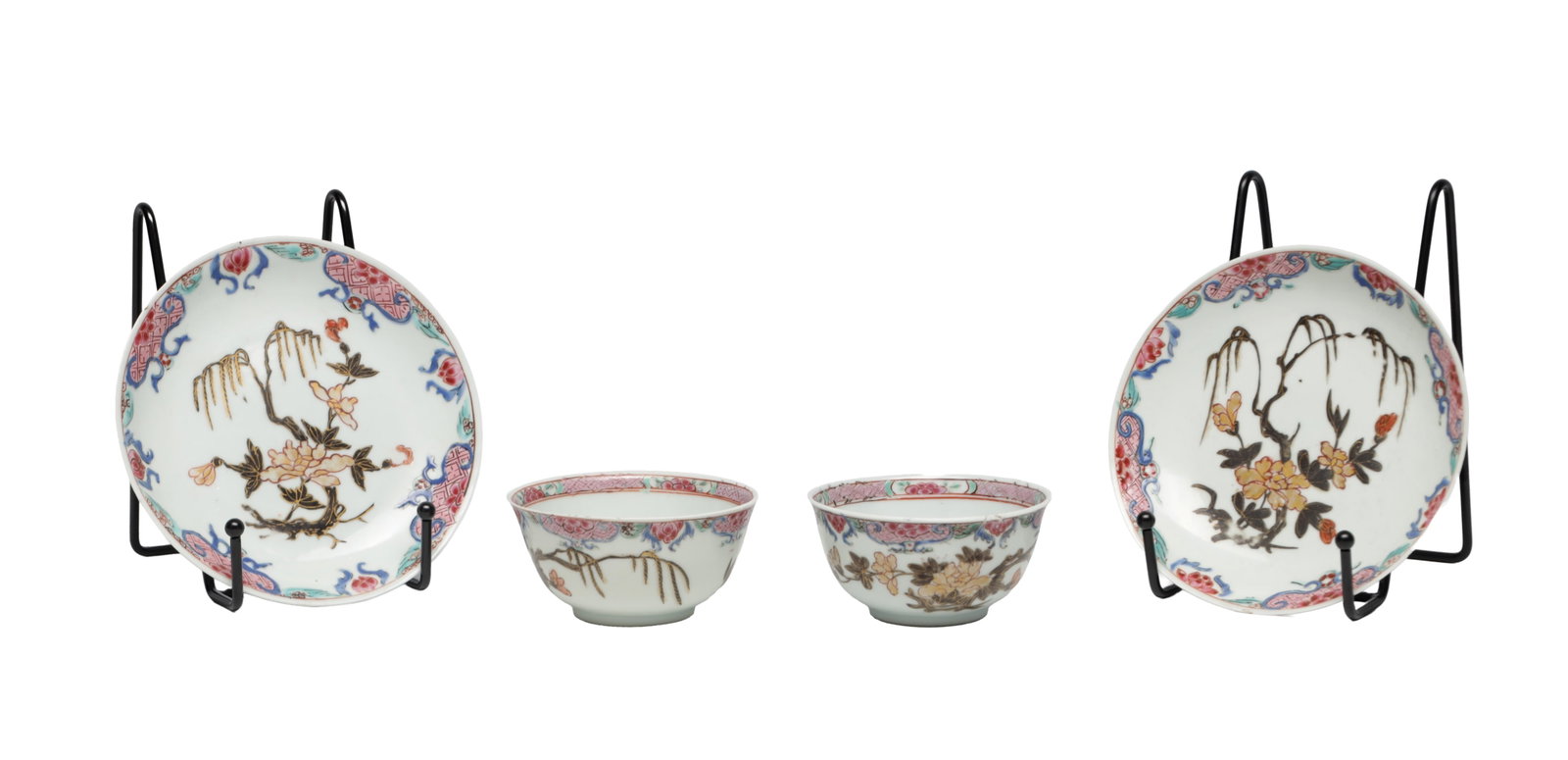 A PAIR OF CHINESE FAMILLE ROSE PORCELAIN TEA BOWLS AND SAUCERS: A PAIR OF CHINESE FAMILLE ROSE PORCELAIN TEA BOWLS AND SAUCERS each enamelled with peony and willow sprays, the rims with pink diaper and turquoise ruyi borders, the bowls with continuous floral