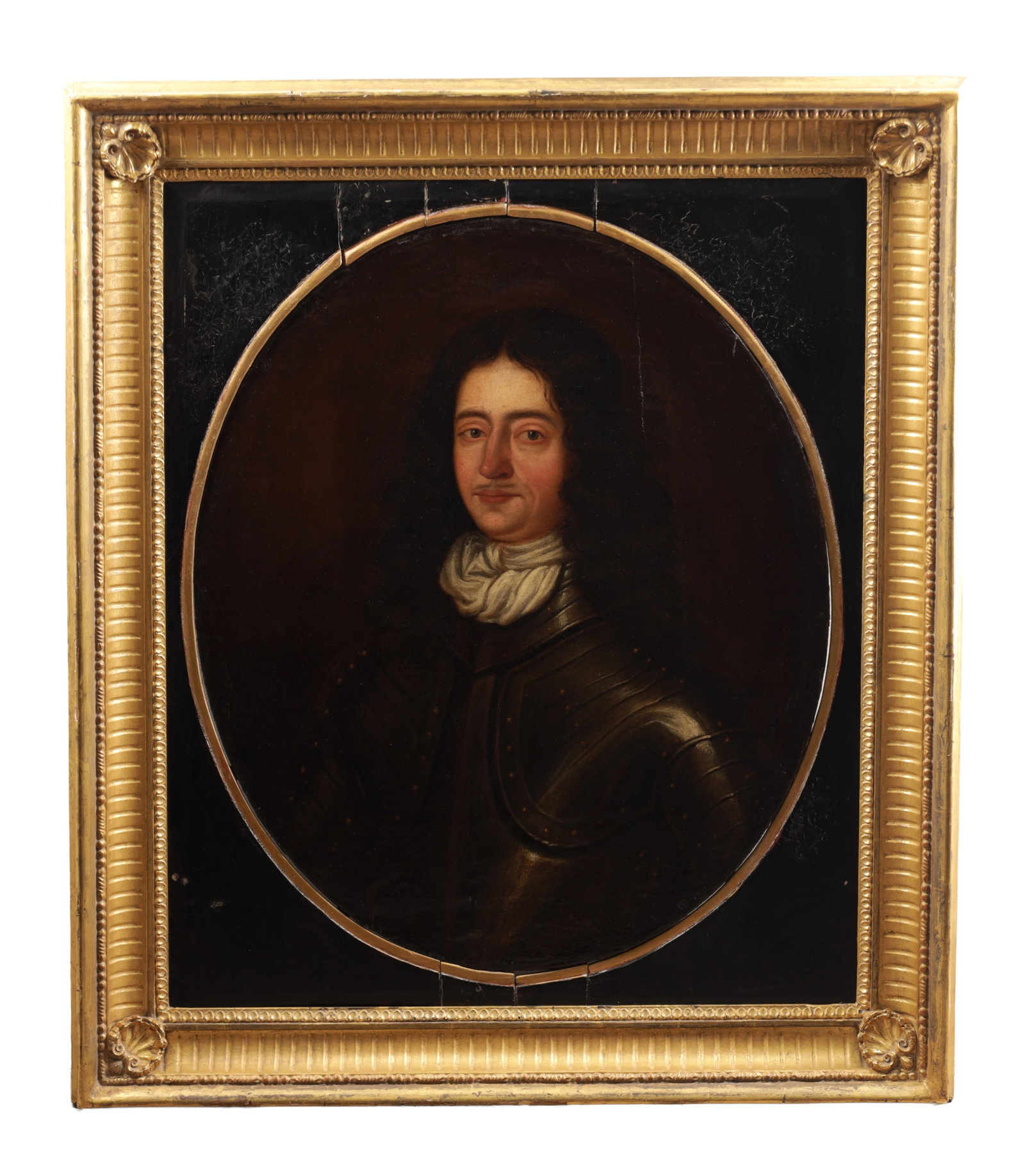 A 17TH CENTURY OIL ON BOARD PORTRAIT OF A GENTLEMAN: A 17TH CENTURY OIL ON BOARD PORTRAIT OF A GENTLEMAN depicting a half-length sitter in armour with a white cravat within an oval reserve on a dark ground, mounted in a giltwood frame. (76cm high, 64cm