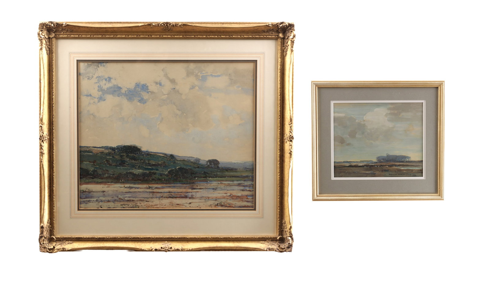 KERSHAW SCHOFIELD BRITISH (1875-1941) TWO EARLY 20TH CENTURY WATERCOLOURS: KERSHAW SCHOFIELD BRITISH (1875-1941) TWO EARLY 20TH CENTURY WATERCOLOURS landscape studies with expansive skies over low horizons, each mounted and gilt framed. (49.5cm high, 59cm wide; 25.5cm high,