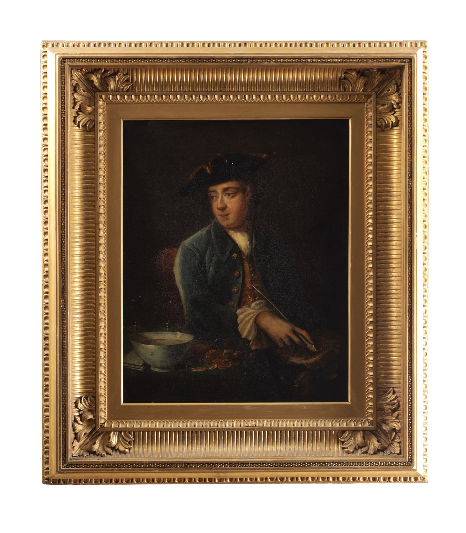 AN 18TH CENTURY OIL ON CANVAS PORTRAIT OF A GENTLEMAN: AN 18TH CENTURY OIL ON CANVAS PORTRAIT OF A GENTLEMAN depicting a half-length sitter wearing a tricorn hat and blue coat on a dark ground, mounted in a carved, gilt frame. (52.5cm high, 41.5cm wide)