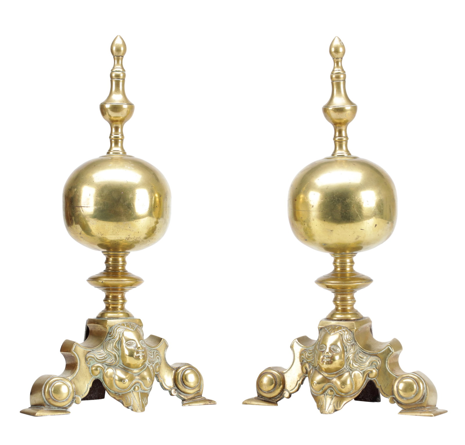 A PAIR OF LATE 19TH CENTURY GILT AND POLISHED BRASS FIRE DOGS: A PAIR OF LATE 19TH CENTURY GILT AND POLISHED BRASS FIRE DOGS with turned spire finials above large spherical knops, raised on triform scrolled bases cast with female mask mounts and disc roundels.