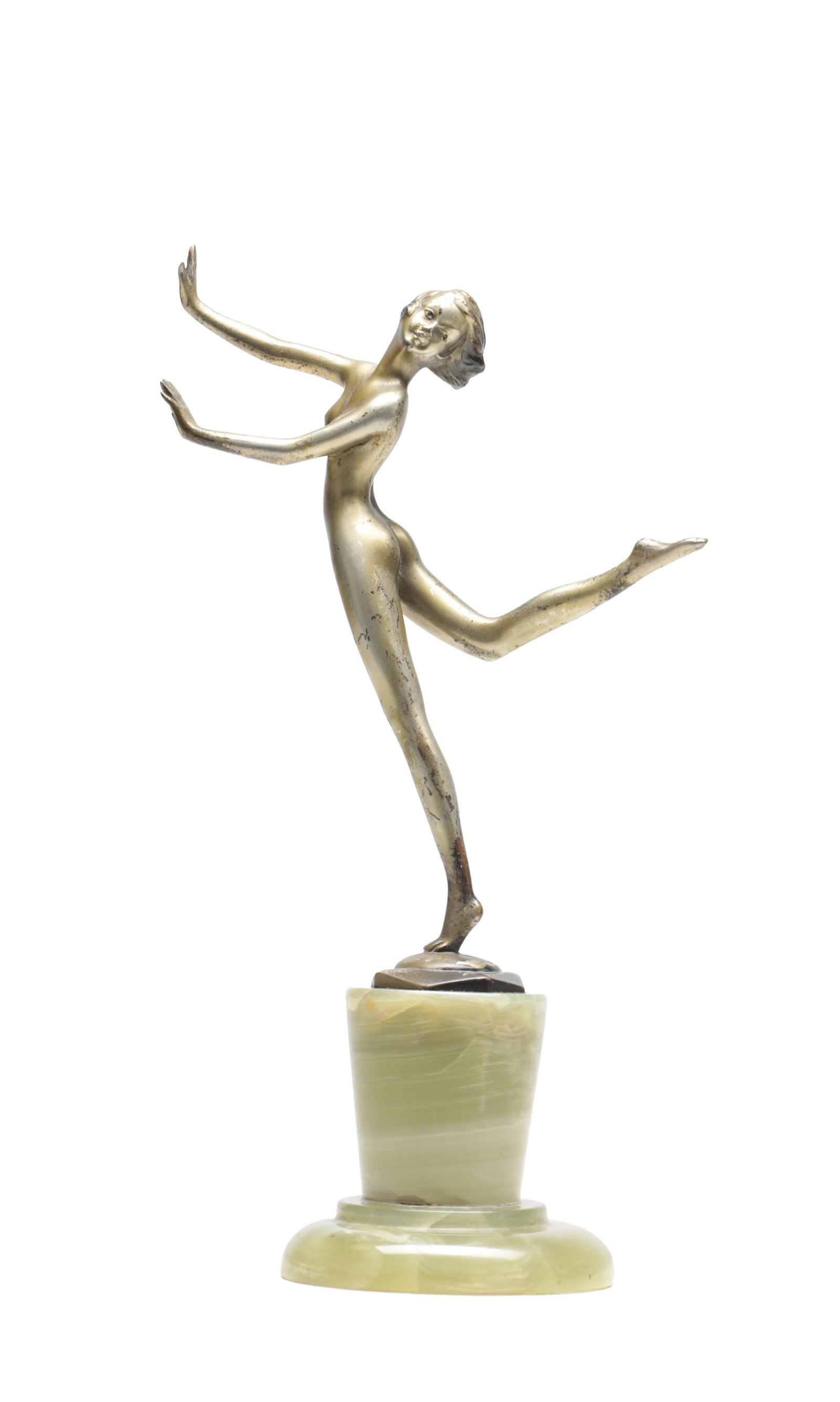 IN THE MANNER OF LORENZL AN ART DECO BRONZE FIGURE OF A DANCING GIRL ON A GREEN ONYX BASE: IN THE MANNER OF LORENZL AN ART DECO BRONZE FIGURE OF A DANCING GIRL ON A GREEN ONYX BASE depicting a nude dancer poised with outstretched arms and one leg raised with a silvered patinated finish. (27
