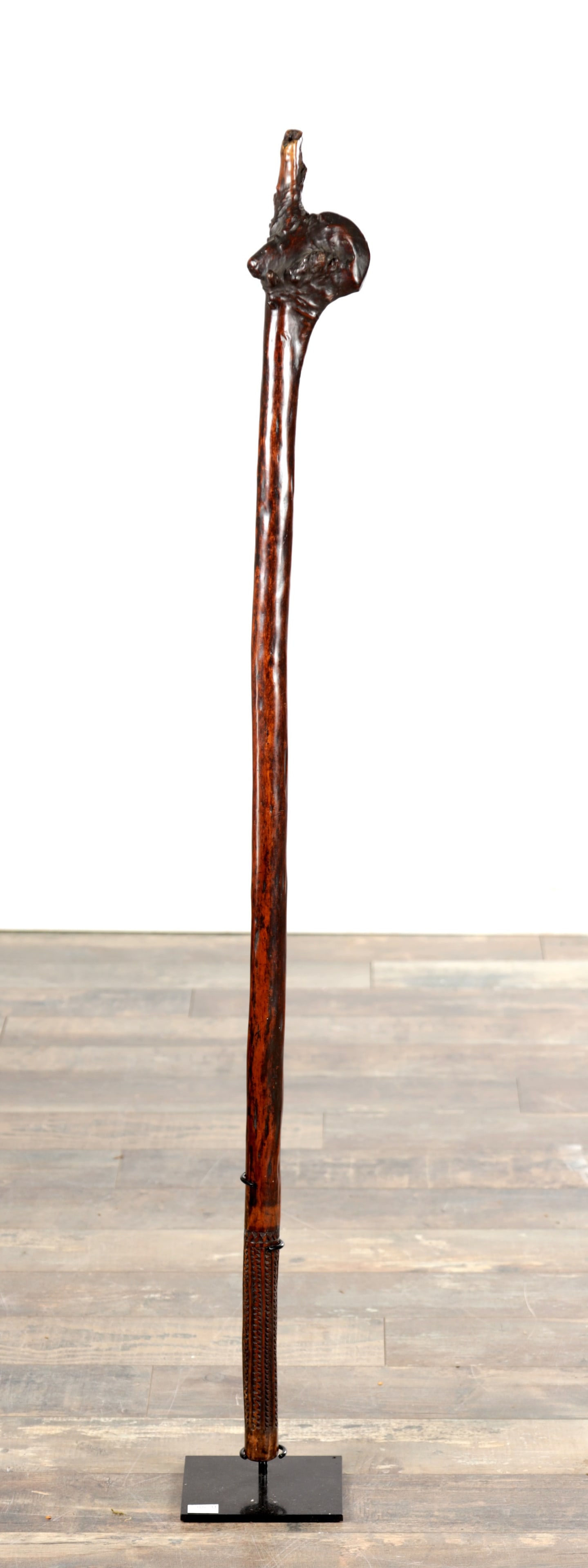 A FIJI ISLANDS CARVED WOOD ROOTSTOCK CLUB: A FIJI ISLANDS CARVED WOOD ROOTSTOCK CLUB of long tapering form with a natural root butt head, the lower grip finely incised with zig-zag chevron decoration. (114cm long)