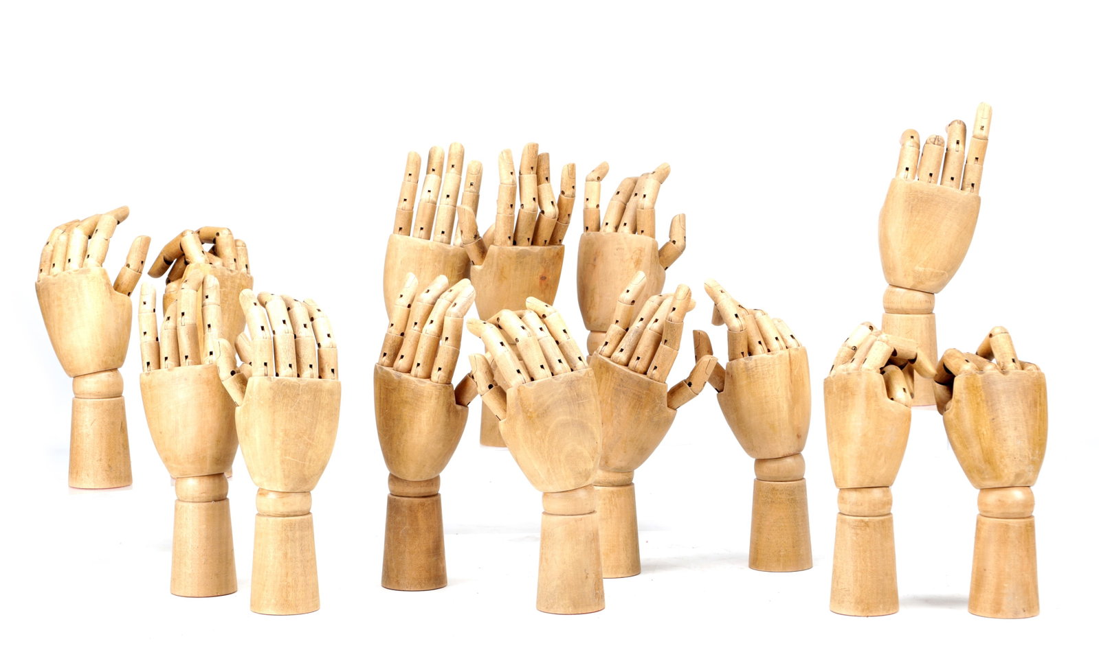 A COLLECTION OF FOURTEEN 20TH CENTURY WOODEN METAMORPHIC SHOP HANDS (1 of 2)