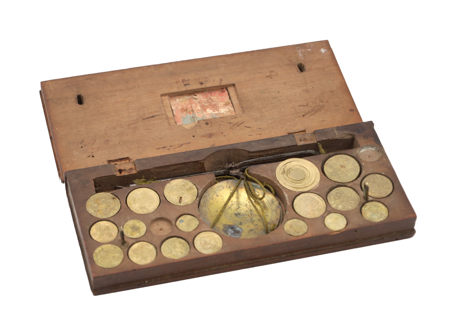 A RARE SET OF LATE 17TH CENTURY CASED COIN SCALES: A RARE SET OF LATE 17TH CENTURY CASED COIN SCALES comprising a brass beam balance with twin pans and an assortment of circular brass coin weights; the fitted wooden case with hinged lid and shaped