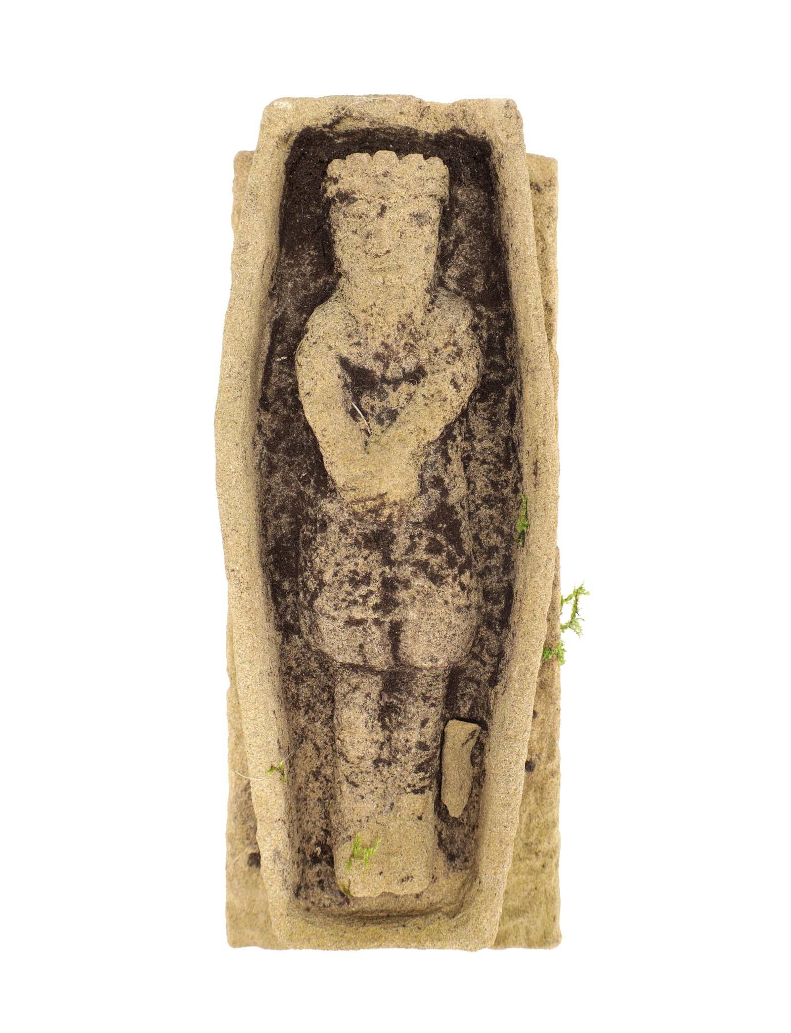 A 16TH CENTURY SANDSTONE RELIEF PANEL: A 16TH CENTURY SANDSTONE RELIEF PANEL depicting a recumbent robed figure with arms crossed within a coffin-shaped niche, carved in shallow relief. (50cm long, 15cm wide, 10cm high)