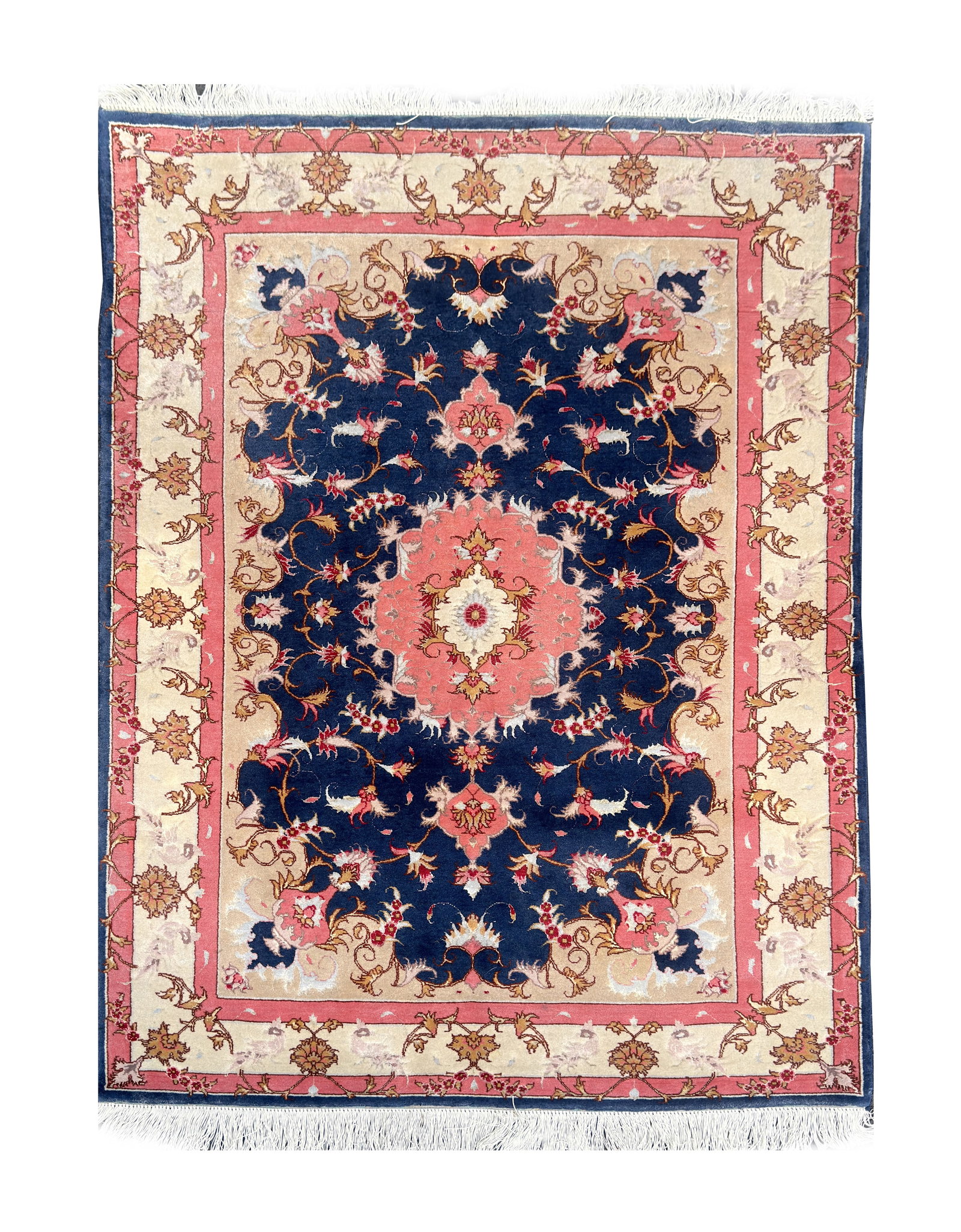 AN IRANIAN HAND-KNOTTED WOOL AND SILK CARPET: AN IRANIAN HAND-KNOTTED WOOL AND SILK CARPET with a lobed central medallion on a dark blue field of scrolling vines and palmettes, within pink and cream floral borders, fringed at each end. (150cm by