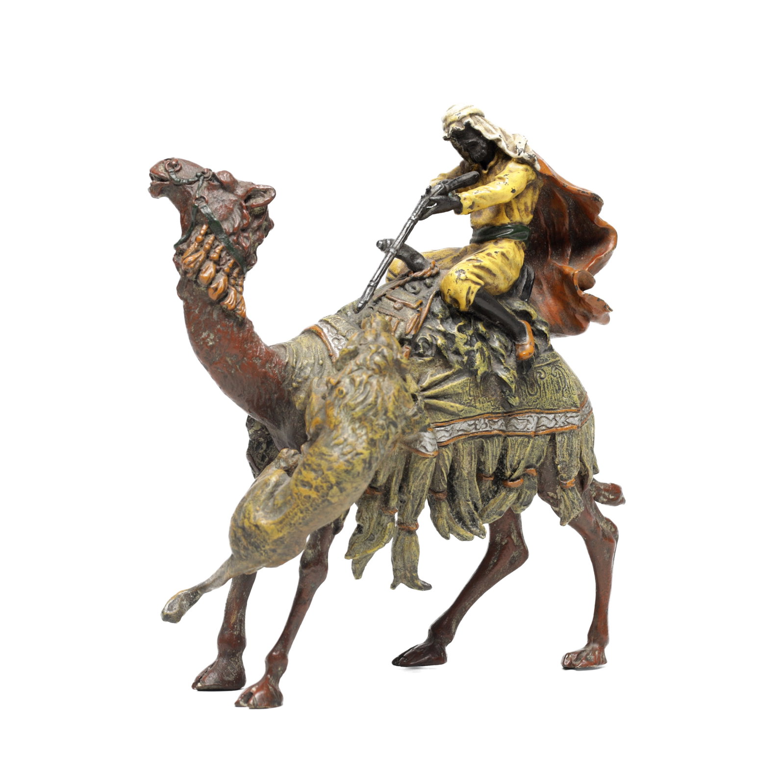 A LATE 19TH CENTURY AUSTRIAN COLD PAINTED BRONZE FRANZ BERGMAN STYLE CAMEL AND RIDER GROUP: A LATE 19TH CENTURY AUSTRIAN COLD PAINTED BRONZE FRANZ BERGMAN STYLE CAMEL AND RIDER GROUP depicting an Arab rider with rifle astride a richly caparisoned camel, the robes and trappings detailed in