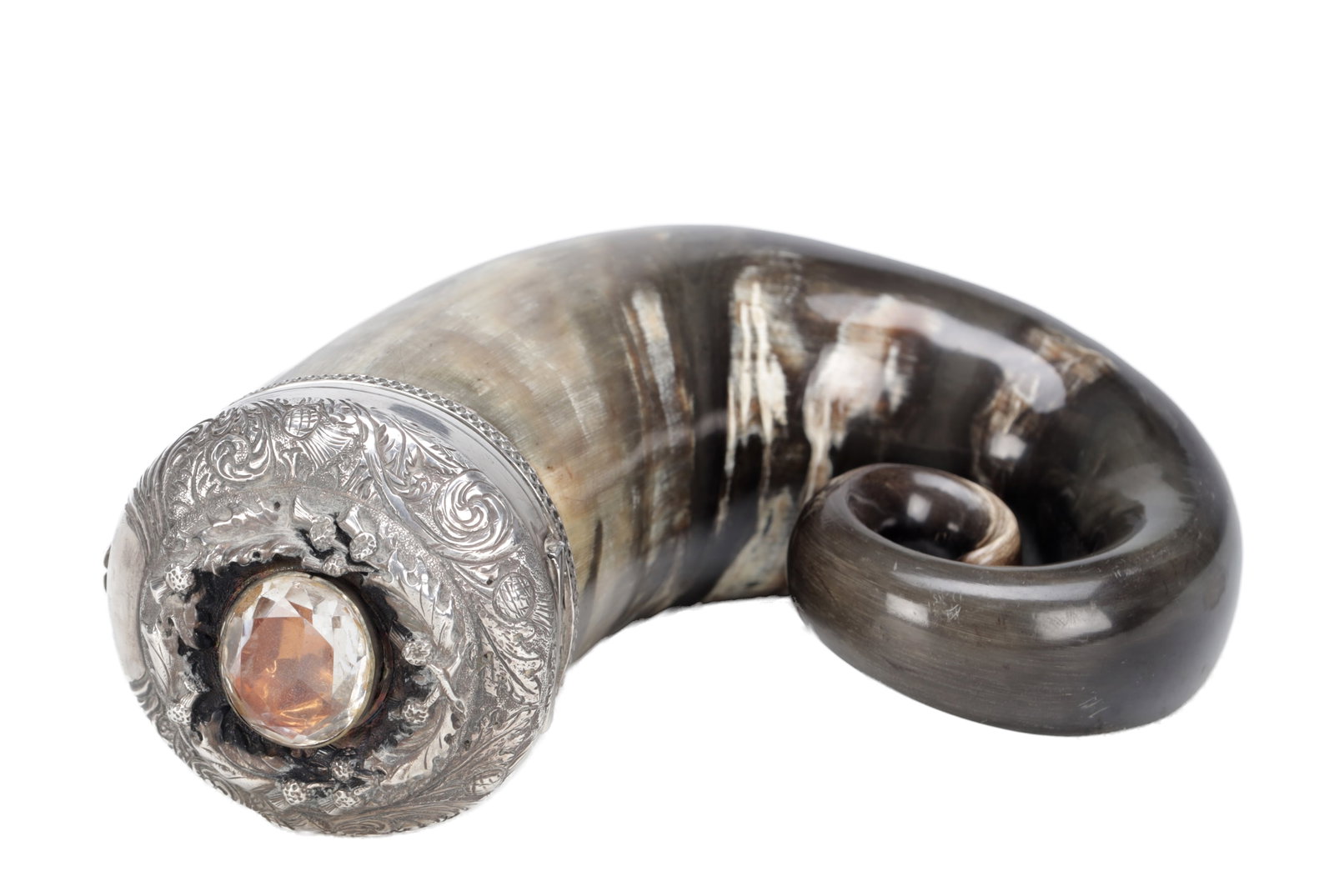 A SCOTTISH SILVER METAL MOUNTED RAM'S HORN SNUFF MULL SET WITH A FACETED CAIRNGORM: A SCOTTISH SILVER METAL MOUNTED RAM'S HORN SNUFF MULL SET WITH A FACETED CAIRNGORM of natural coiled form, the circular mount chased with thistles and scrollwork and centred by an oval faceted