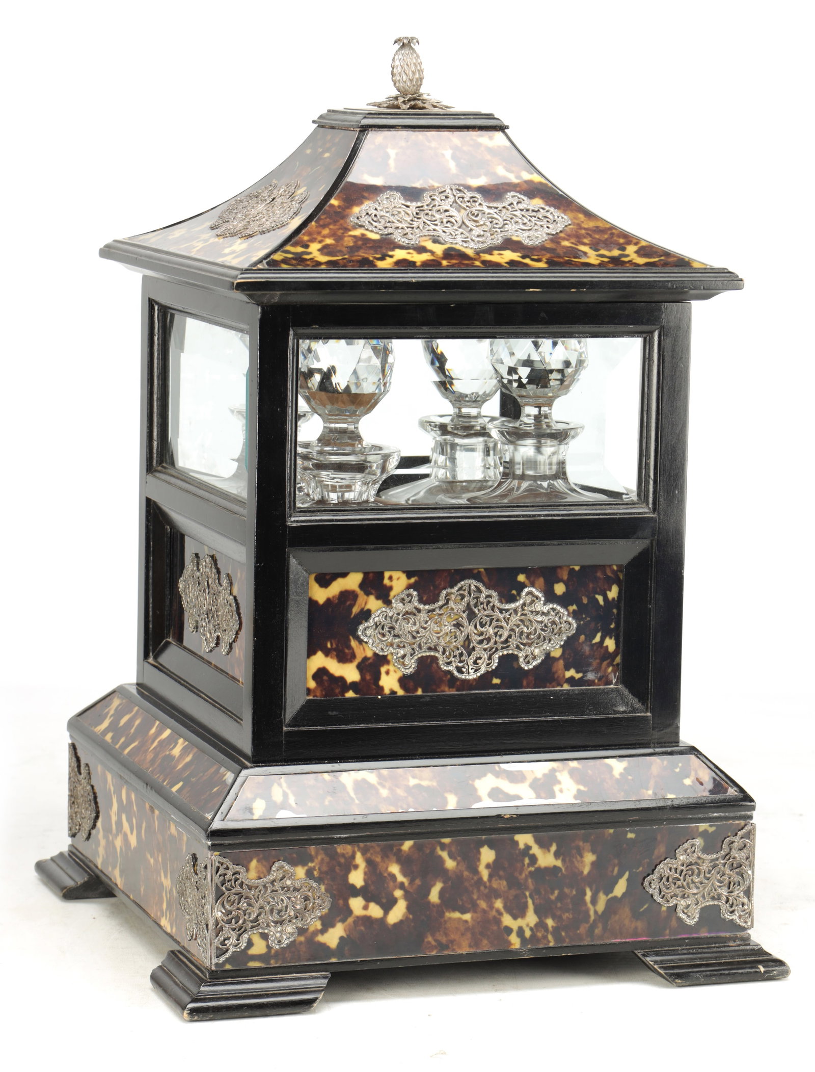 A FINE 19TH CENTURY TORTOISESHELL AND SILVER MOUNTED DECANTER BOX: A FINE 19TH CENTURY TORTOISESHELL AND SILVER MOUNTED DECANTER BOX of pagoda form with a pineapple finial and all-round pierced silver filigree mounts, the tortoiseshell panels set in an ebonised