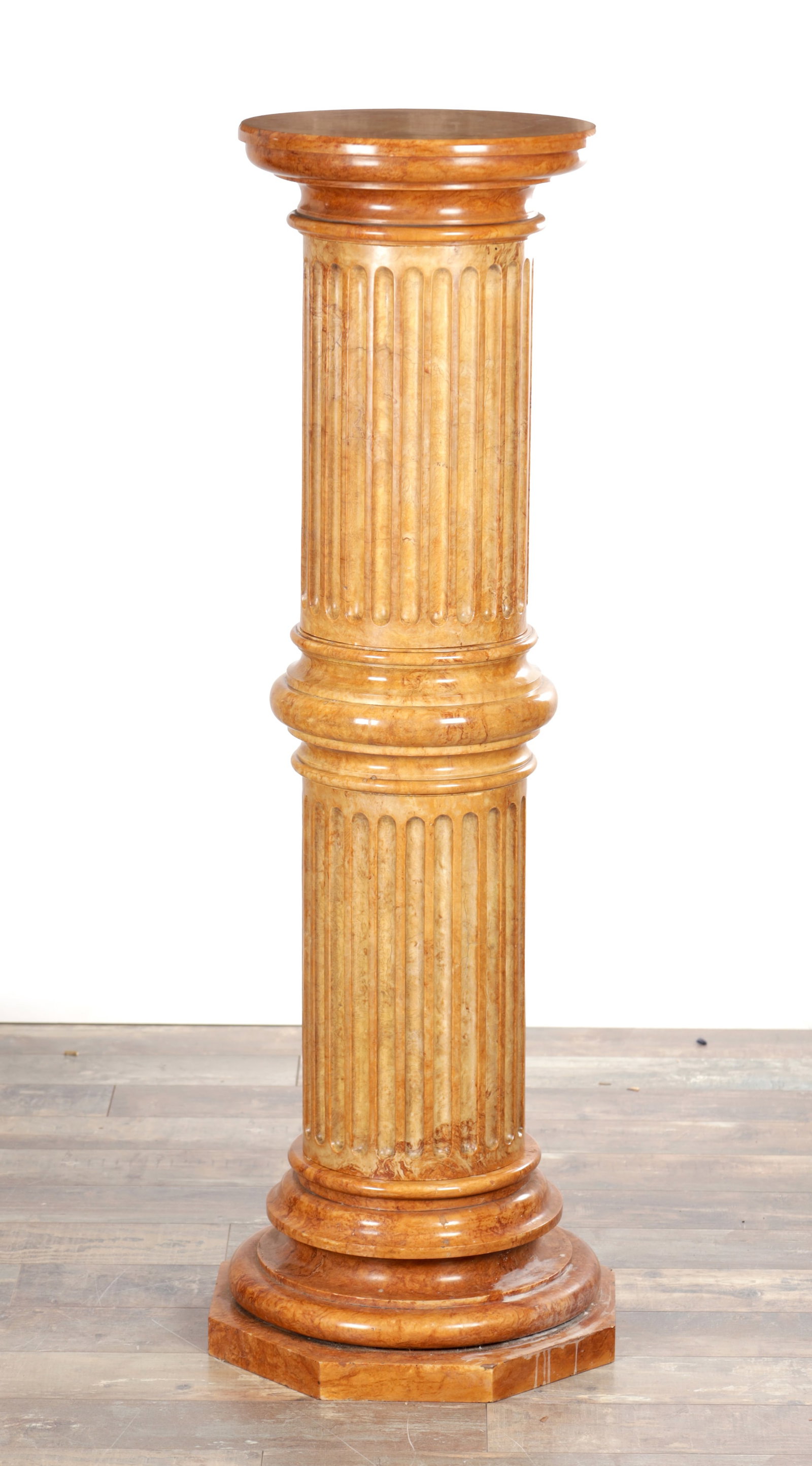 A LARGE SIENNA MARBLE COLUMN: A LARGE SIENNA MARBLE COLUMN of pedestal form having a circular moulded top above a fluted shaft with central collar raised on a stepped circular base over an octagonal plinth. (126cm high, 36cm diame