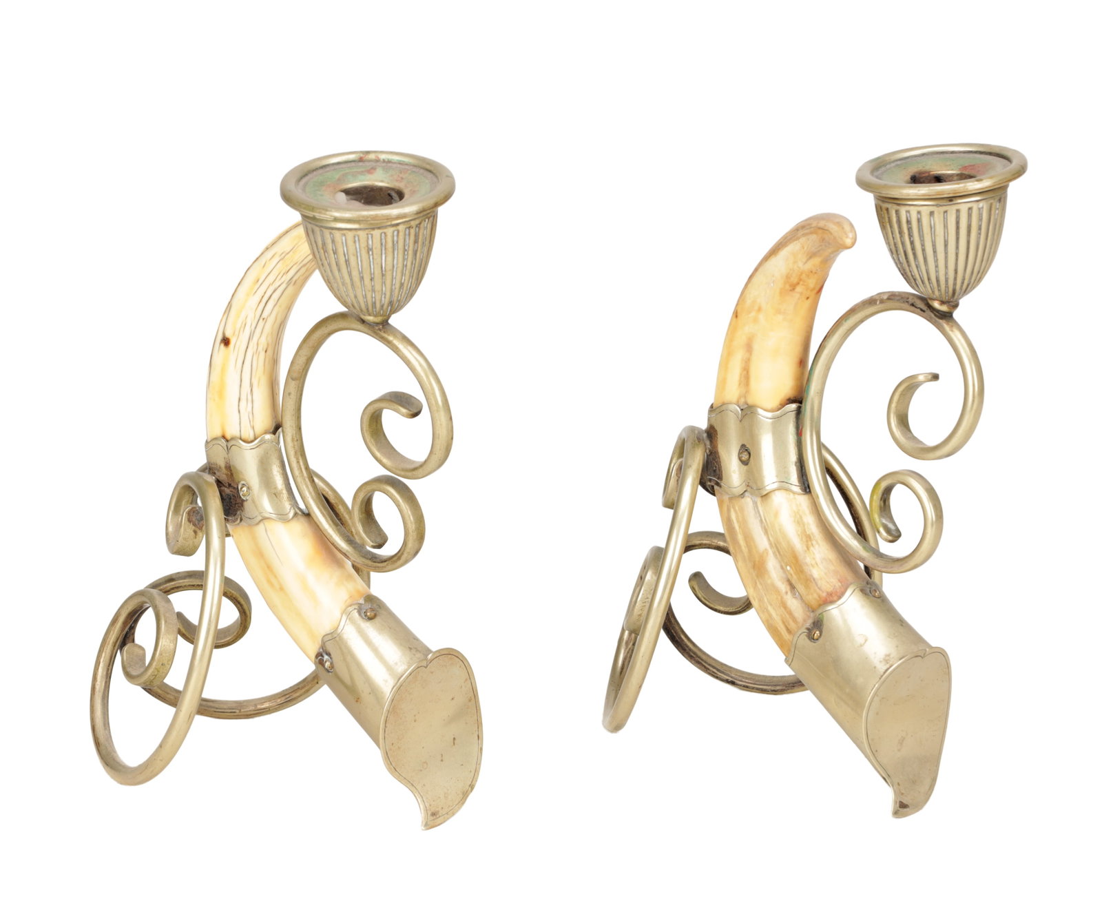 A PAIR OF 19TH CENTURY SILVER PLATE MOUNTED BOAR'S TUSK CANDLESTICKS: A PAIR OF 19TH CENTURY SILVER PLATE MOUNTED BOAR'S TUSK CANDLESTICKS with fluted sconces, shaped collars and caps, the natural tusks supported by open scroll wirework bases. (25cm high (each))
