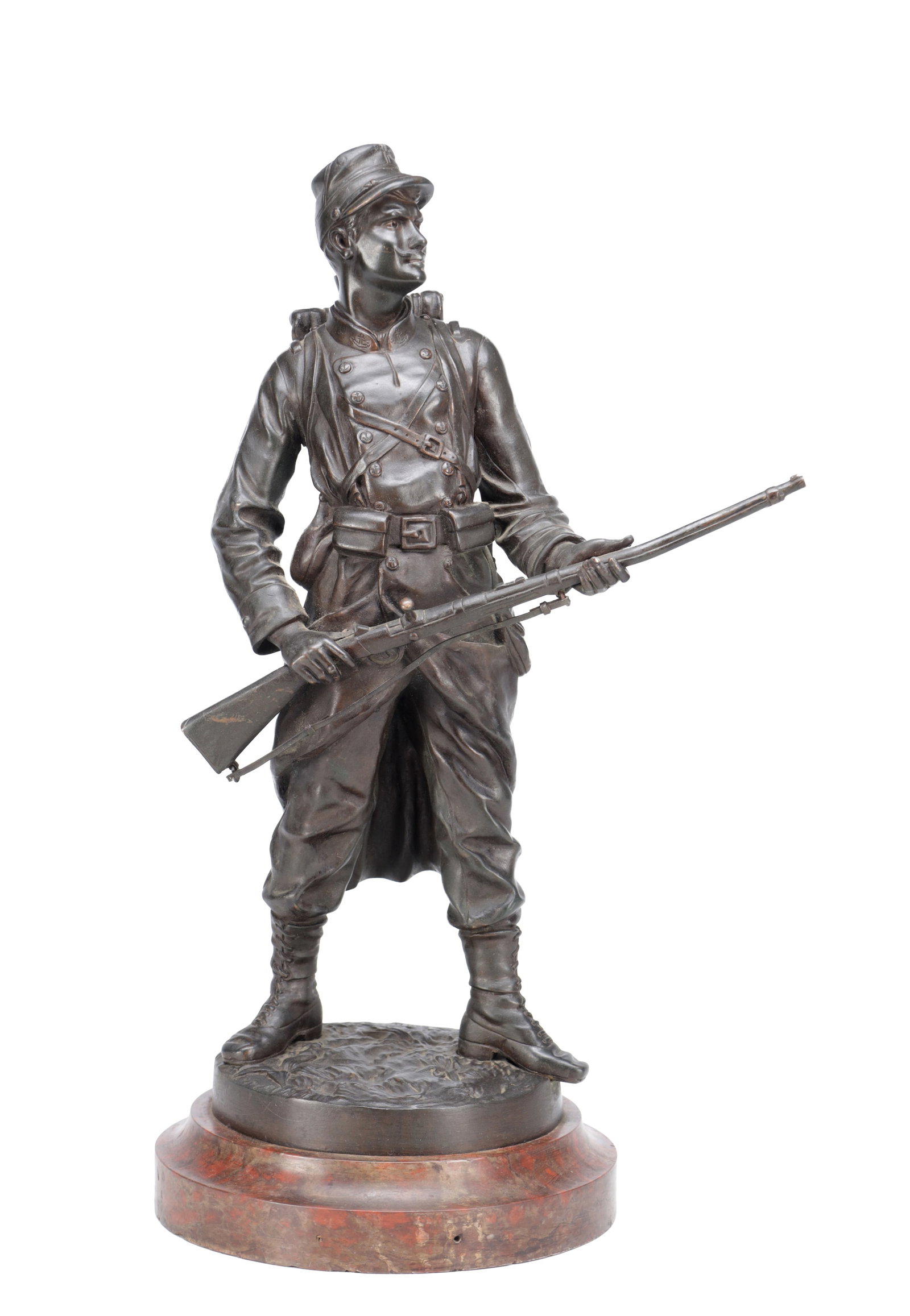 EMILE GUILLEMIN (FRENCH, 1841-1907) A PATINATED BRONZE FIGURE OF A SOLDIER: EMILE GUILLEMIN (FRENCH, 1841-1907) A PATINATED BRONZE FIGURE OF A SOLDIER modelled standing at ease holding a rifle across both hands in campaign dress with pack and cap, on a circular naturalistic