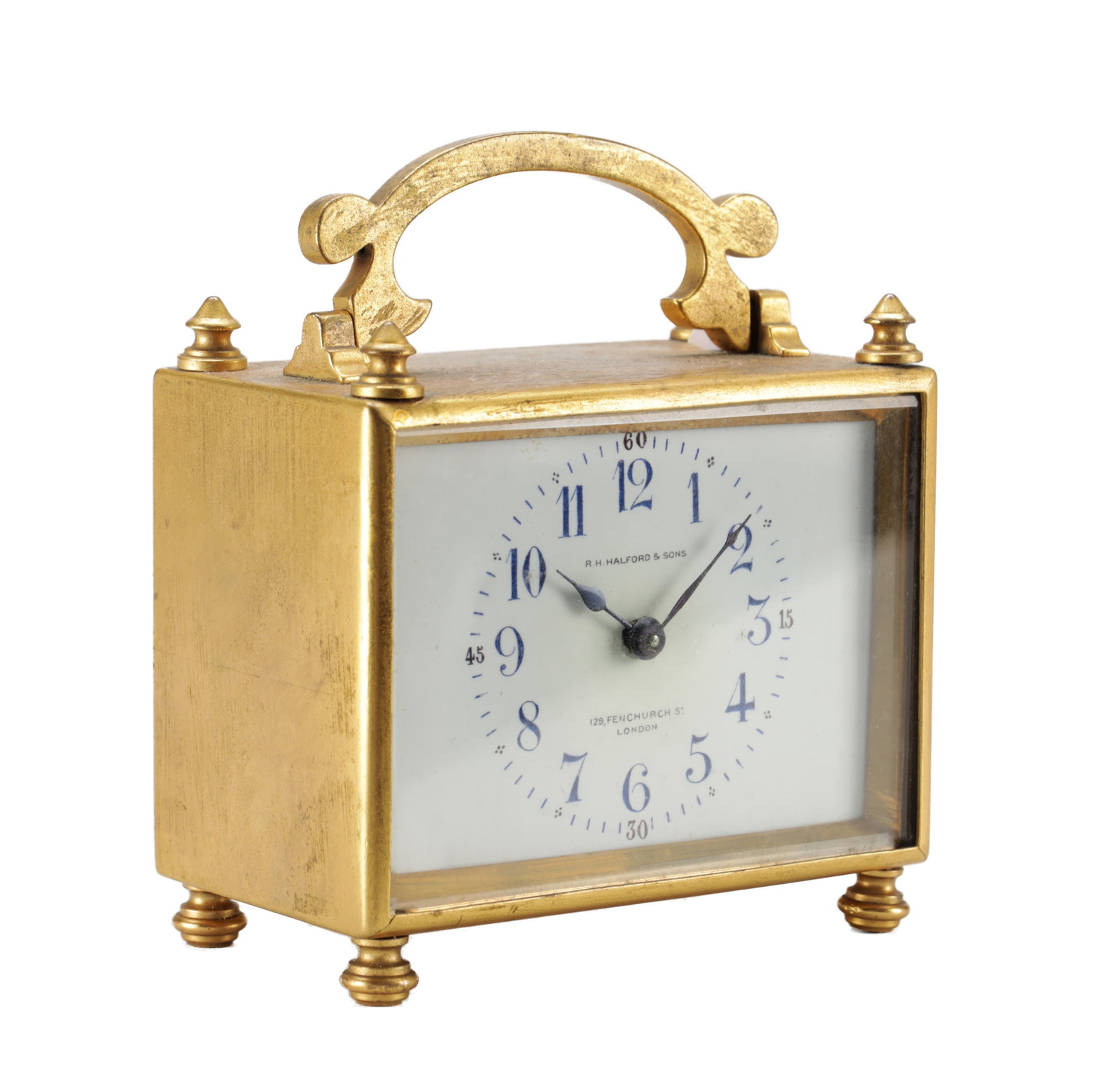 AN EARLY 20TH CENTURY FRENCH GILT BRASS CARRIAGE CLOCK TIMEPIECE: AN EARLY 20TH CENTURY FRENCH GILT BRASS CARRIAGE CLOCK TIMEPIECE with a rectangular case, scroll swing handle, corner finials and bun feet, the enamel dial with blue Arabic numerals signed R. H. Halfo