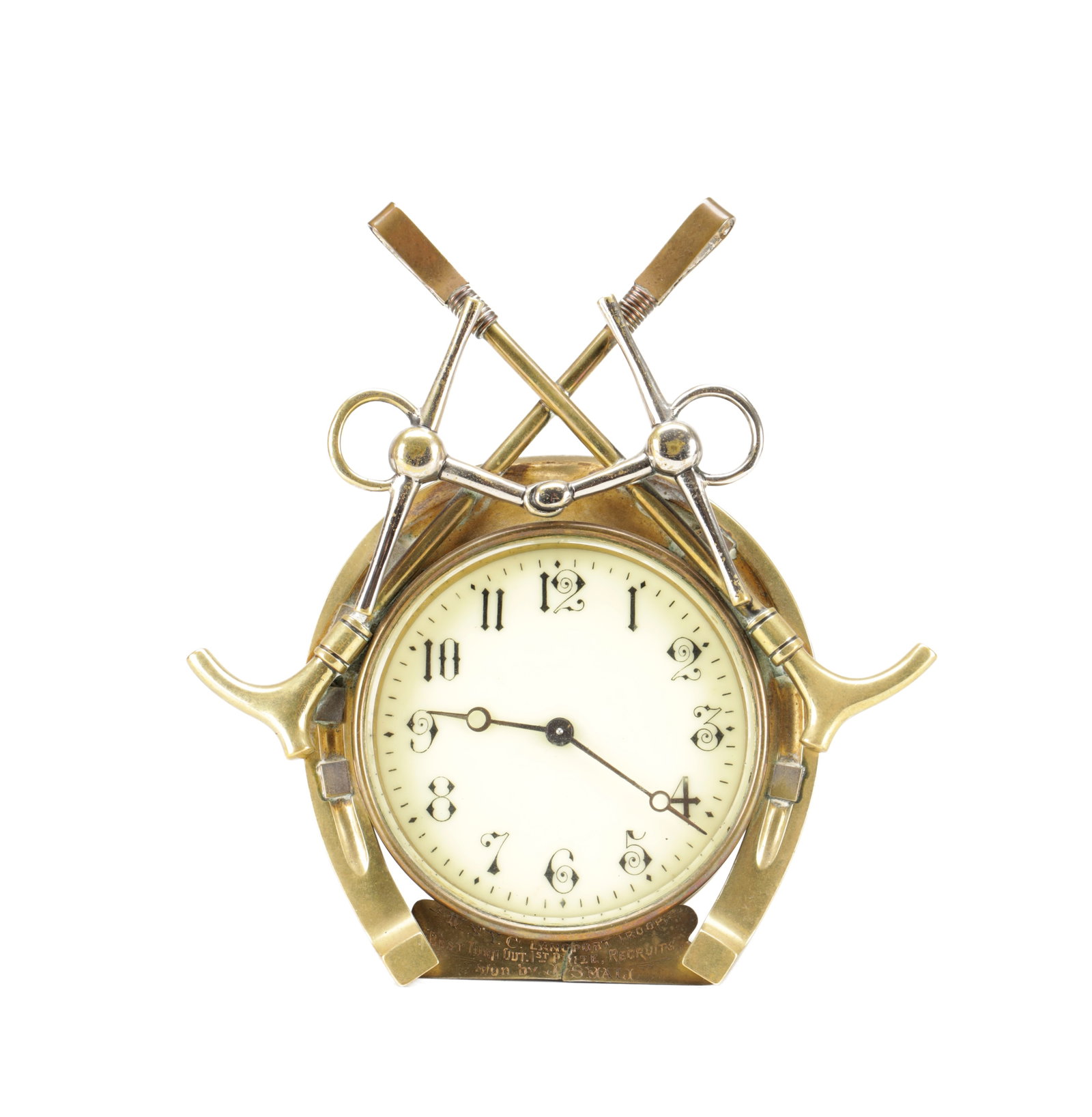 A LATE 19TH CENTURY BRASS EQUESTRIAN DESK CLOCK: A LATE 19TH CENTURY BRASS EQUESTRIAN DESK CLOCK with a 3 1/2 inch enamel dial fronting an eight day spring driven movement, within a horseshoe frame surmounted by crossed polo mallets and a snaffle bi