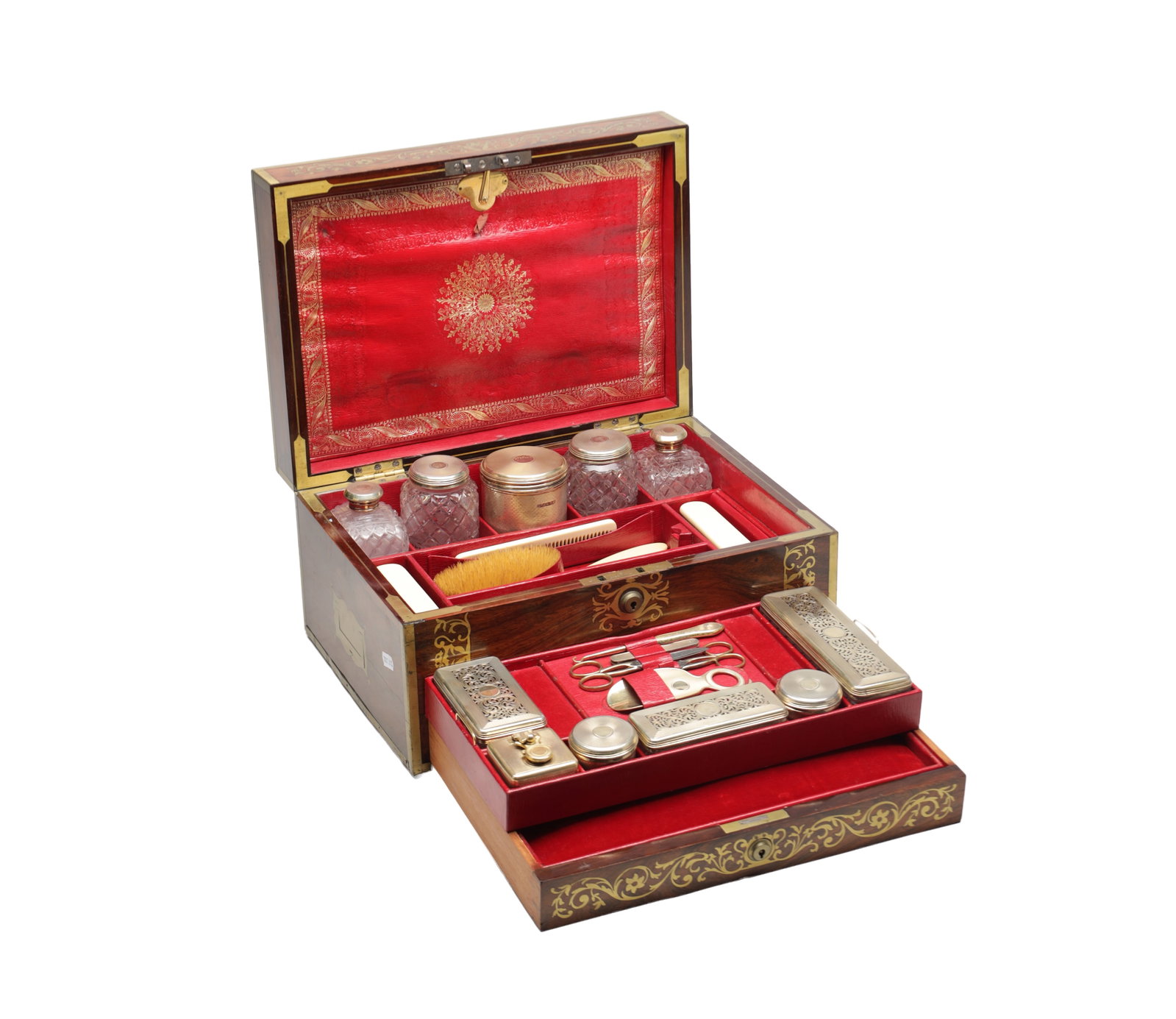 ASPREY OF LONDON A ROSEWOOD AND BRASS BOUND DRESSING CASE WITH SILVER GILT FITTINGS: ASPREY OF LONDON A ROSEWOOD AND BRASS BOUND DRESSING CASE WITH SILVER GILT FITTINGS of rectangular form, the hinged lid opening to a tooled red leather panel and a fitted interior with cut glass jars 