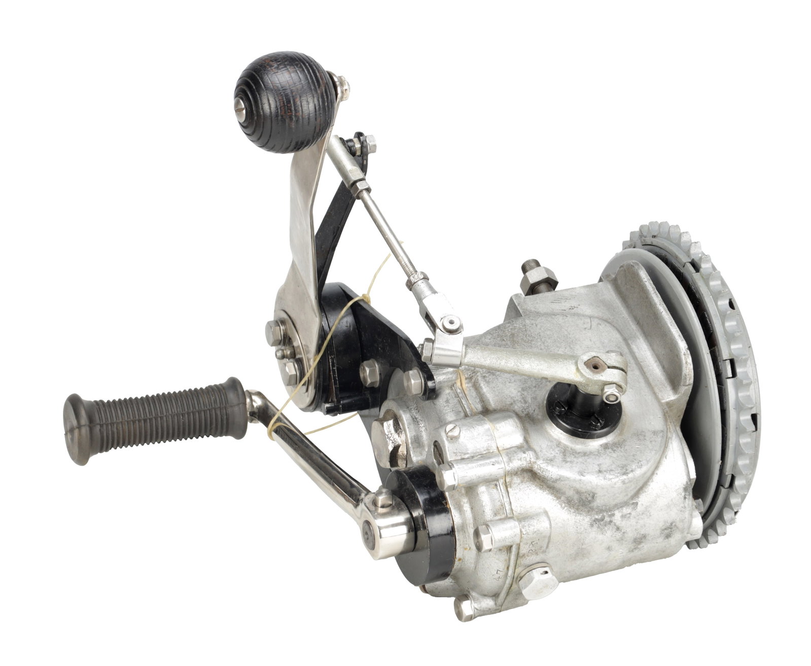 A VINTAGE ALUMINIUM MOTORCYCLE GEARBOX WITH HAND CHANGE LEVER AND KICKSTART: A VINTAGE ALUMINIUM MOTORCYCLE GEARBOX WITH HAND CHANGE LEVER AND KICKSTART of cast alloy construction with external selector linkage and large gear knob, with clutch drum and sprocket to one side,