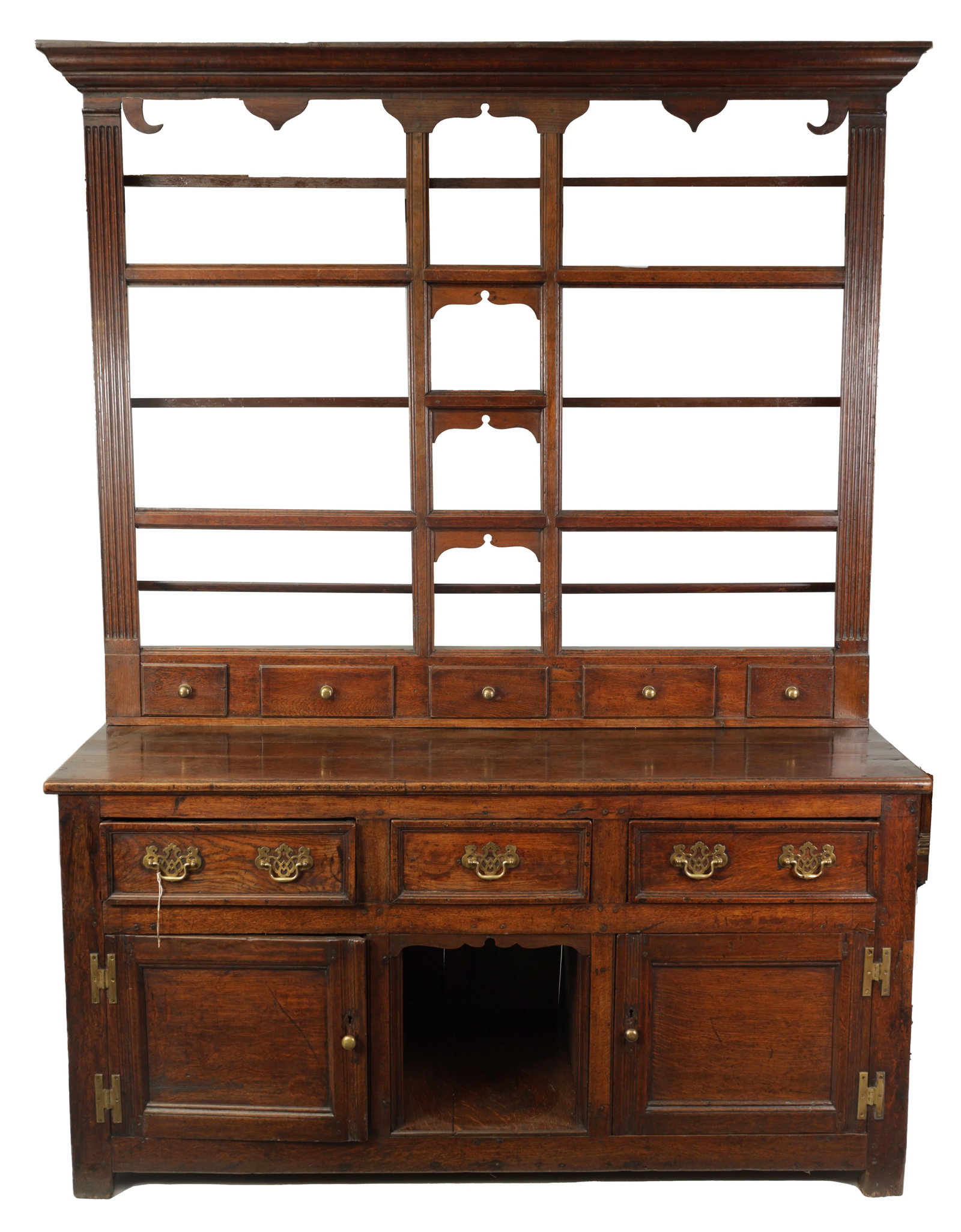 AN EARLY 18TH CENTURY OAK DOG KENNEL DRESSER AND RACK: AN EARLY 18TH CENTURY OAK DOG KENNEL DRESSER AND RACK with a moulded cornice and shaped apron brackets above an open rack with reeded stiles and fixed shelves over a row of small drawers, the