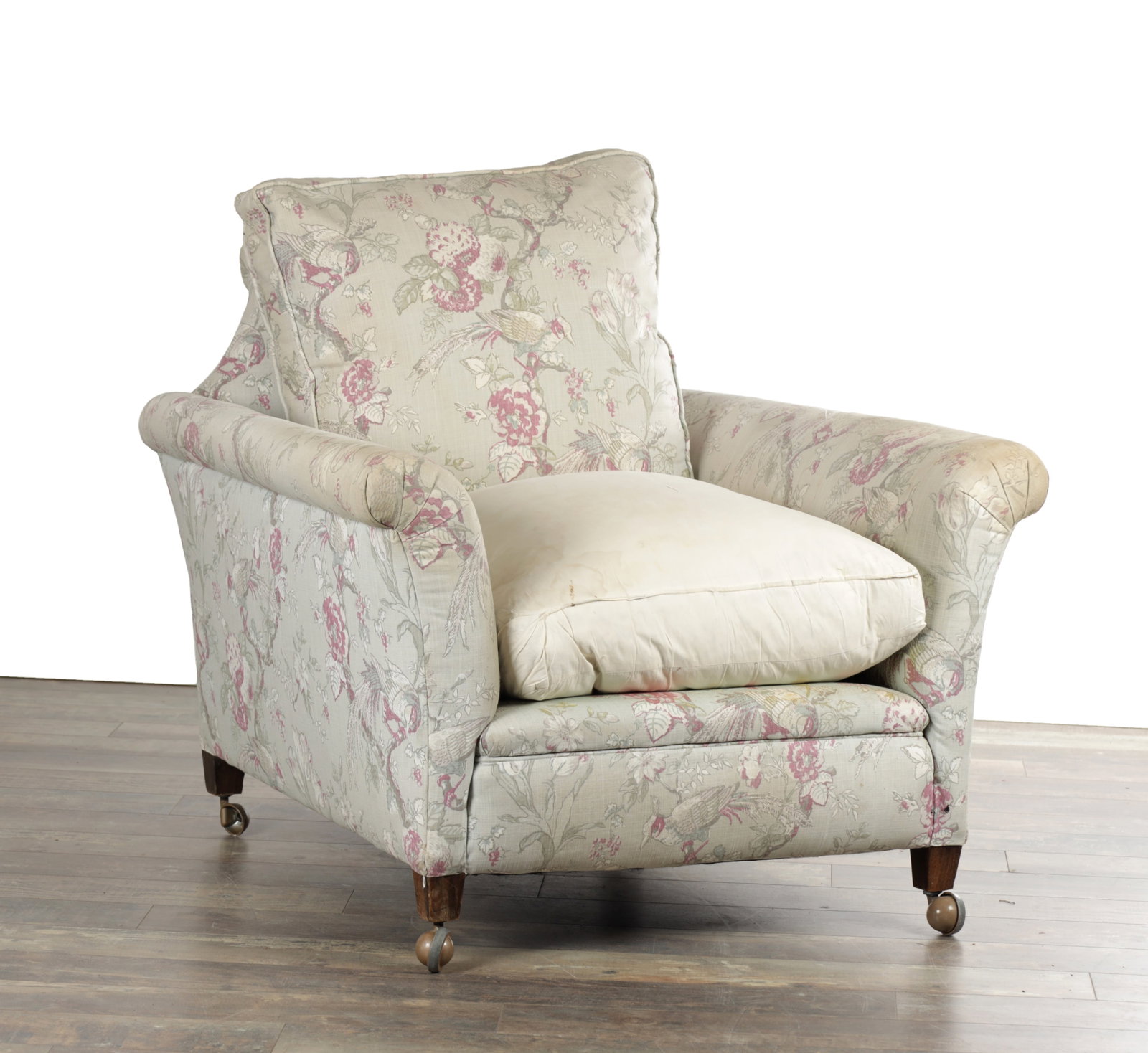 HOWARD & SONS LTD. LONDON, NO84, A 20TH CENTURY UPHOLSTERED ARMCHAIR: HOWARD & SONS LTD. LONDON, NO84, A 20TH CENTURY UPHOLSTERED ARMCHAIR with a cushioned back and loose seat cushion, rolled arms and floral upholstery, raised on short square legs with ball castors. (73