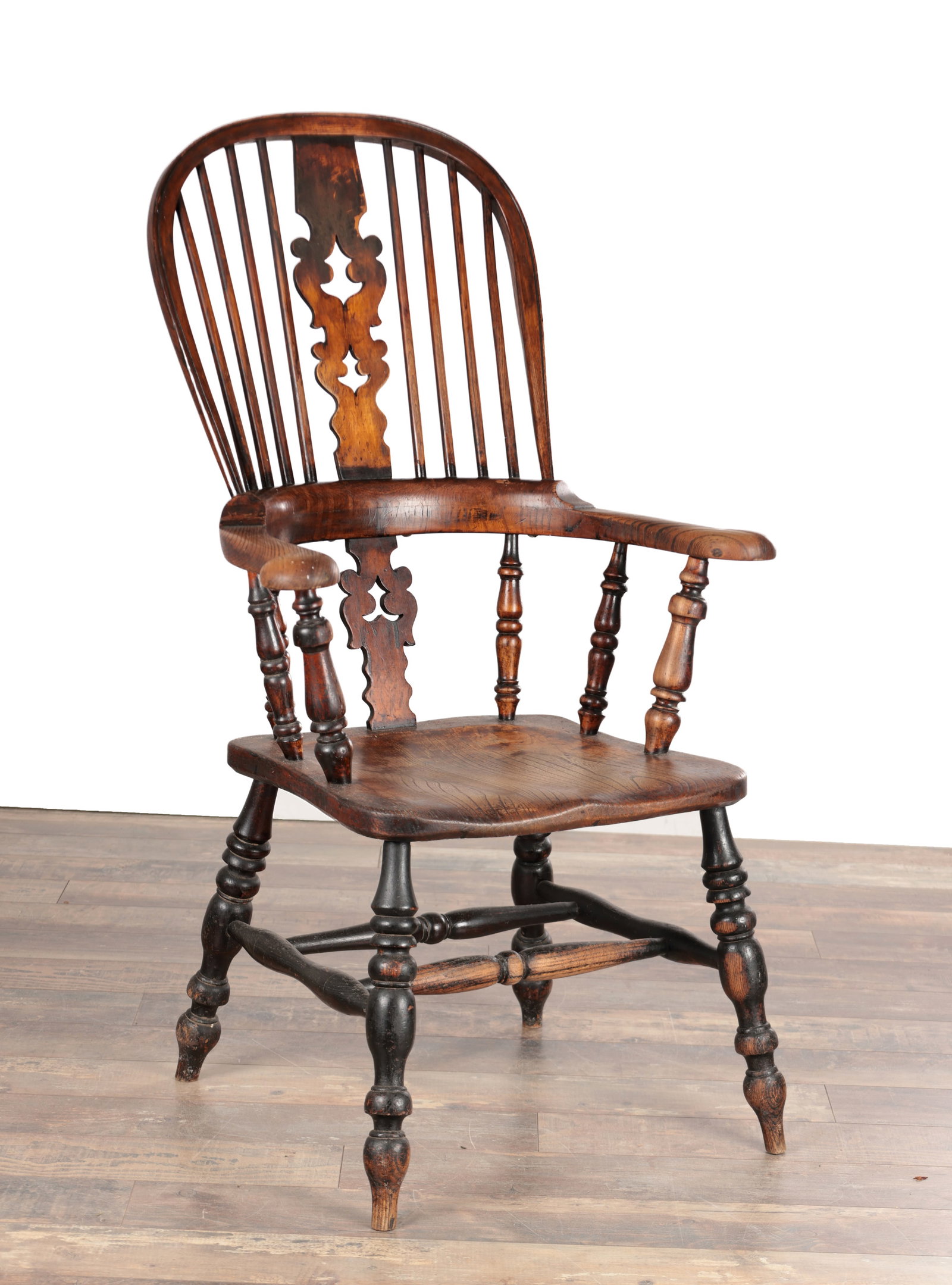 A 19TH CENTURY ASH AND ELM BROAD ARM WINDSOR ARMCHAIR: A 19TH CENTURY ASH AND ELM BROAD ARM WINDSOR ARMCHAIR with hoop back and pierced central splat flanked by spindles, the broad outscrolled arms on turned supports, the shaped single plank seat raised