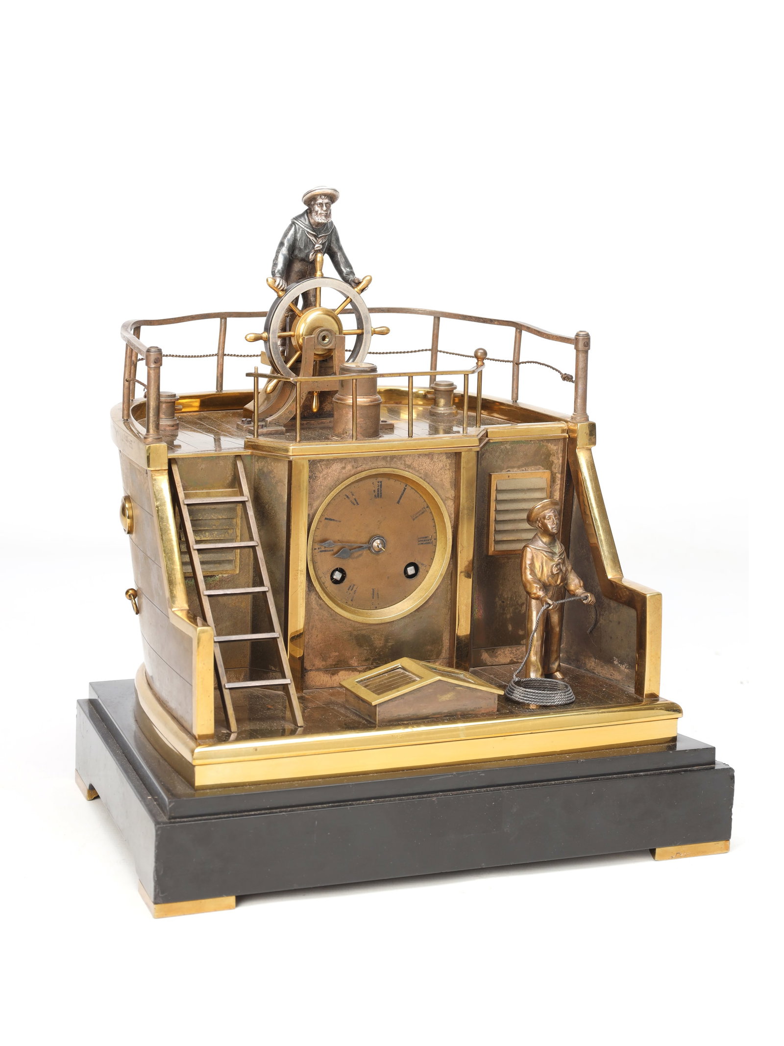 GUILMET, PARIS. A LATE 19TH CENTURY FRENCH INDUSTRIAL AUTOMATION 'HELMSMAN' TABLE CLOCK: GUILMET, PARIS. A LATE 19TH CENTURY FRENCH INDUSTRIAL AUTOMATION 'HELMSMAN' TABLE CLOCK having a brass ship's deck case with railings, ladder and sailor automata, enclosing a circular Roman dial.