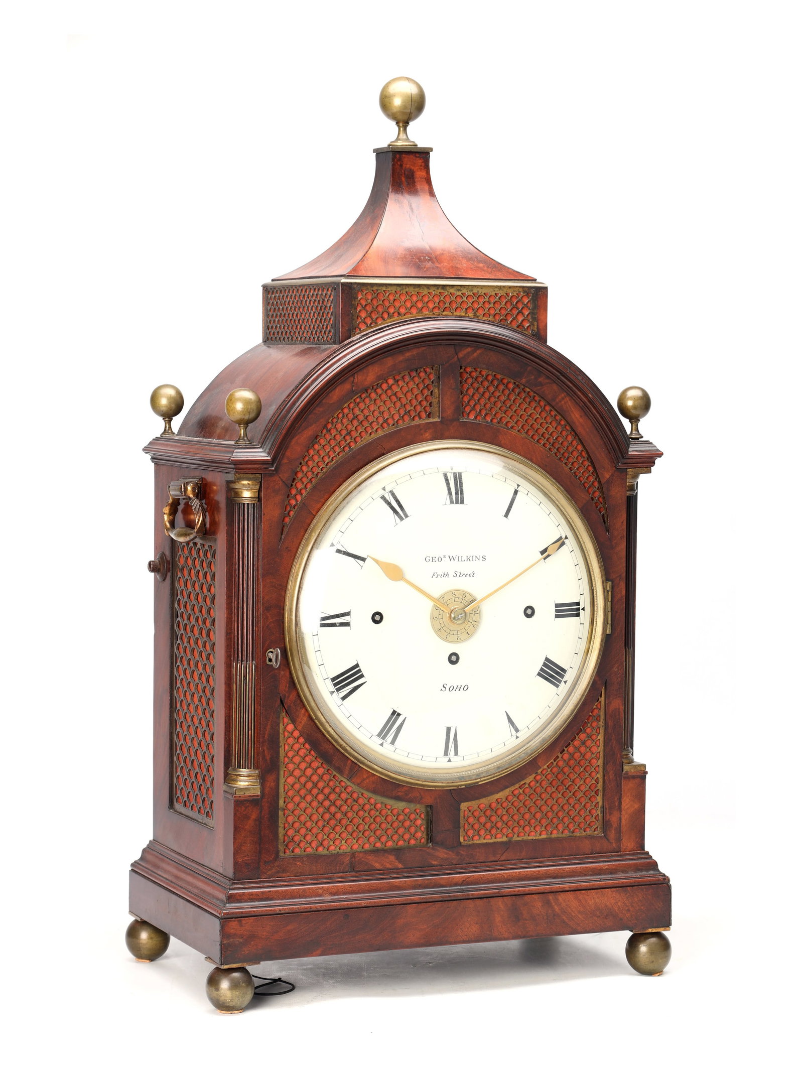 GEORGE WILKINS, SOHO. A REGENCY FIGURED MAHOGANY QUARTER CHIMING BRACKET CLOCK WITH ALARM: GEORGE WILKINS, SOHO. A REGENCY FIGURED MAHOGANY QUARTER CHIMING BRACKET CLOCK WITH ALARM having a pagoda top with brass ball finial, fretwork panels, reeded quarter columns, and plinth base raised on