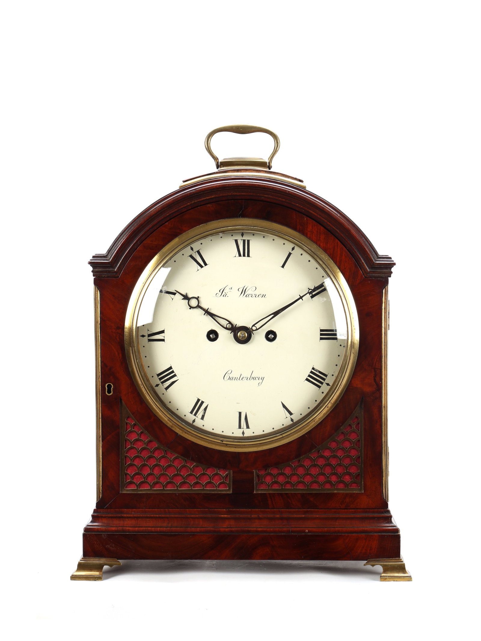 JAMES WARREN, CANTERBURY. A GEORGE III FIGURED MAHOGANY PAD TOP VERGE BRACKET CLOCK: JAMES WARREN, CANTERBURY. A GEORGE III FIGURED MAHOGANY PAD TOP VERGE BRACKET CLOCK with brass carrying handle and pierced fishscale sound frets, on a stepped plinth with brass bracket feet enclosing 