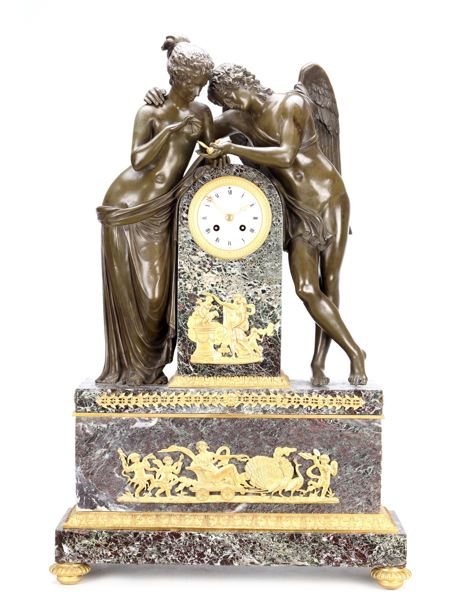 A LARGE 19TH CENTURY FRENCH PATINATED AND GILT BRONZE AND MARBLE FIGURAL MANTEL CLOCK: A LARGE 19TH CENTURY FRENCH PATINATED AND GILT BRONZE AND MARBLE FIGURAL MANTEL CLOCK the arched variegated marble case flanked by a patinated bronze group of Cupid and Psyche, enclosing a circular wh