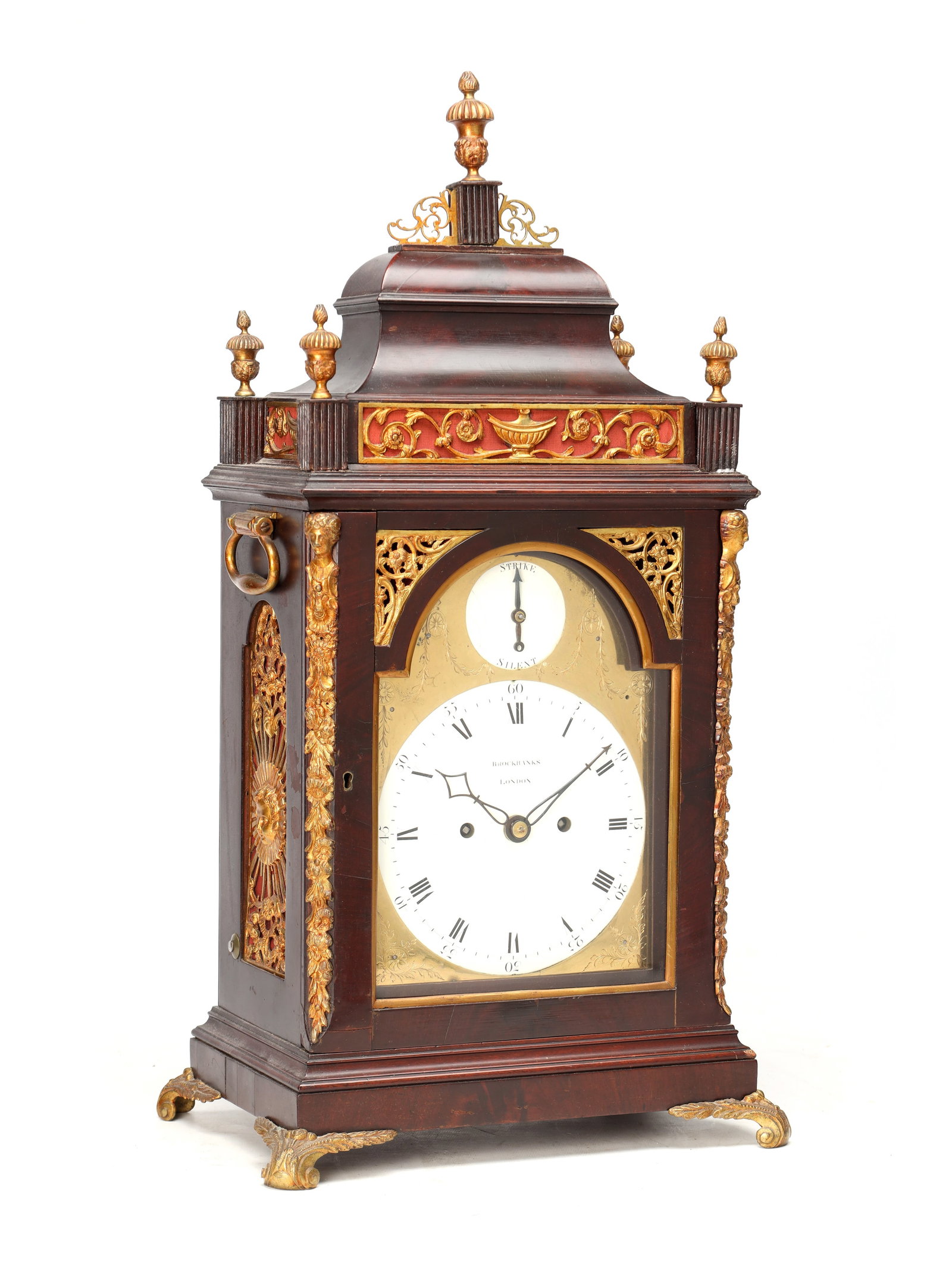 BROCKBANKS, LONDON. A GEORGE III ORMOLU MOUNTED MAHOGANY VERGE BRACKET CLOCK: BROCKBANKS, LONDON. A GEORGE III ORMOLU MOUNTED MAHOGANY VERGE BRACKET CLOCK the mahogany case with inverted bell top surmounted by urn finials, pierced gilt-metal frieze and side panels, canted angle